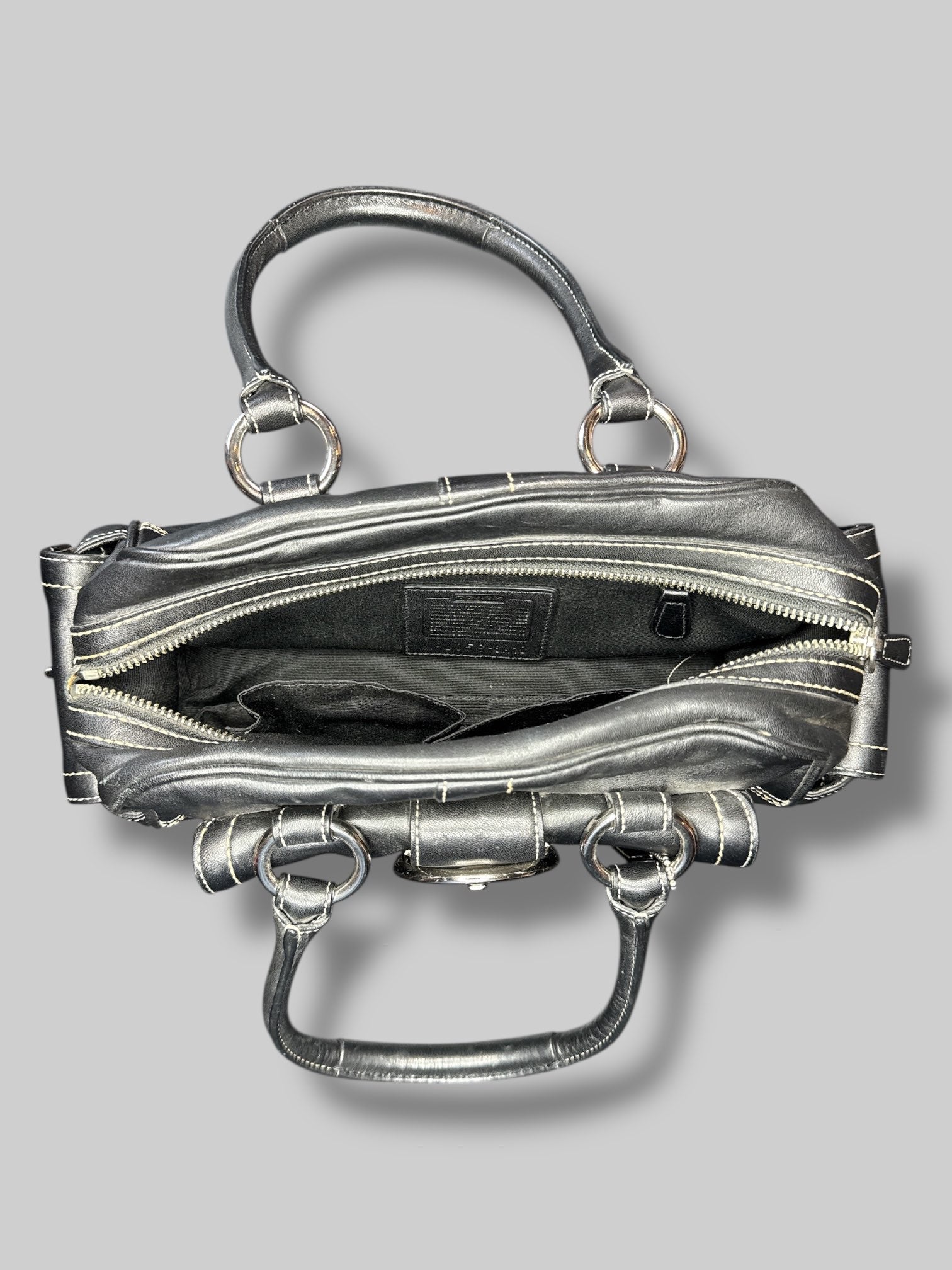 Black leather Coach hand bag with multiple pockets inside and out
