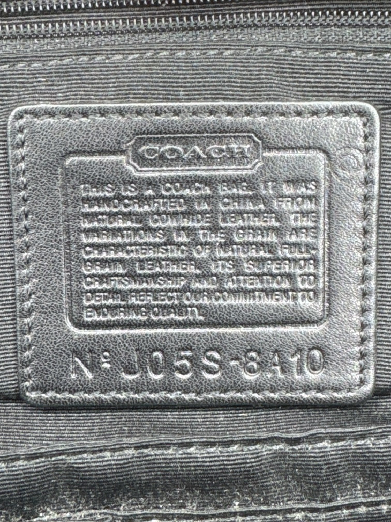 Black leather Coach hand bag with multiple pockets inside and out