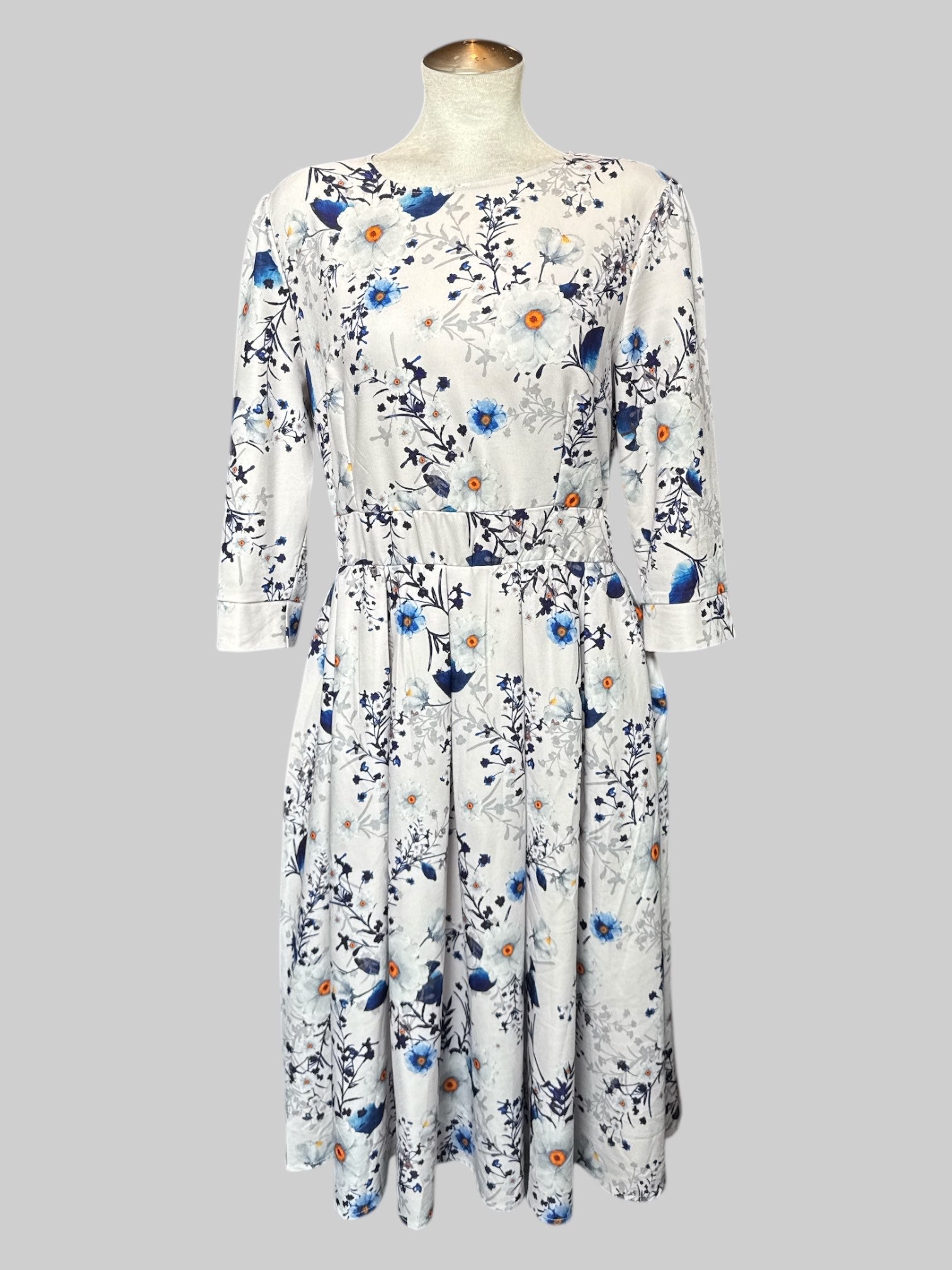 L Off white dress with white and blue florals, quarter sleeves, and back zipper