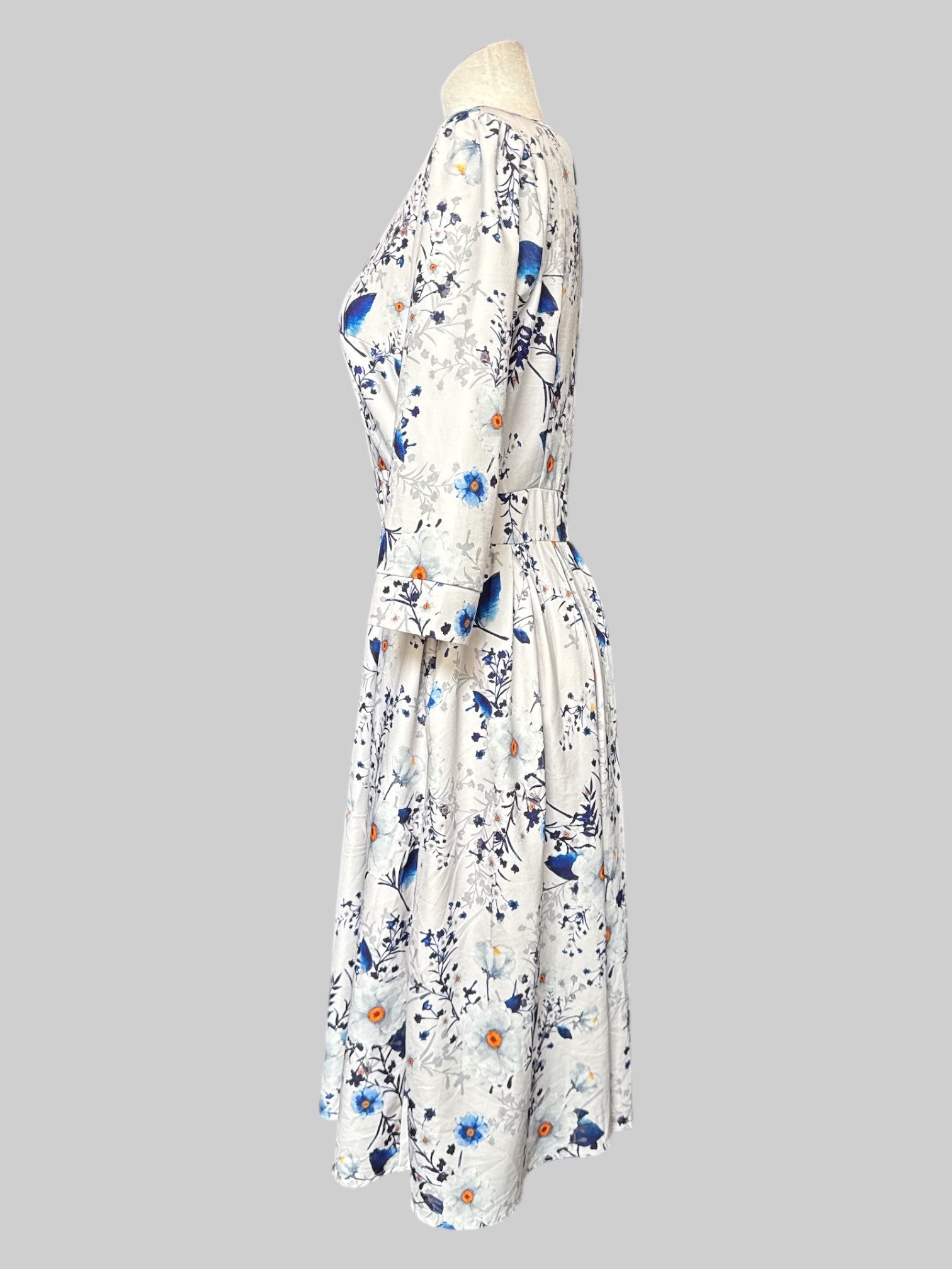 L Off white dress with white and blue florals, quarter sleeves, and back zipper