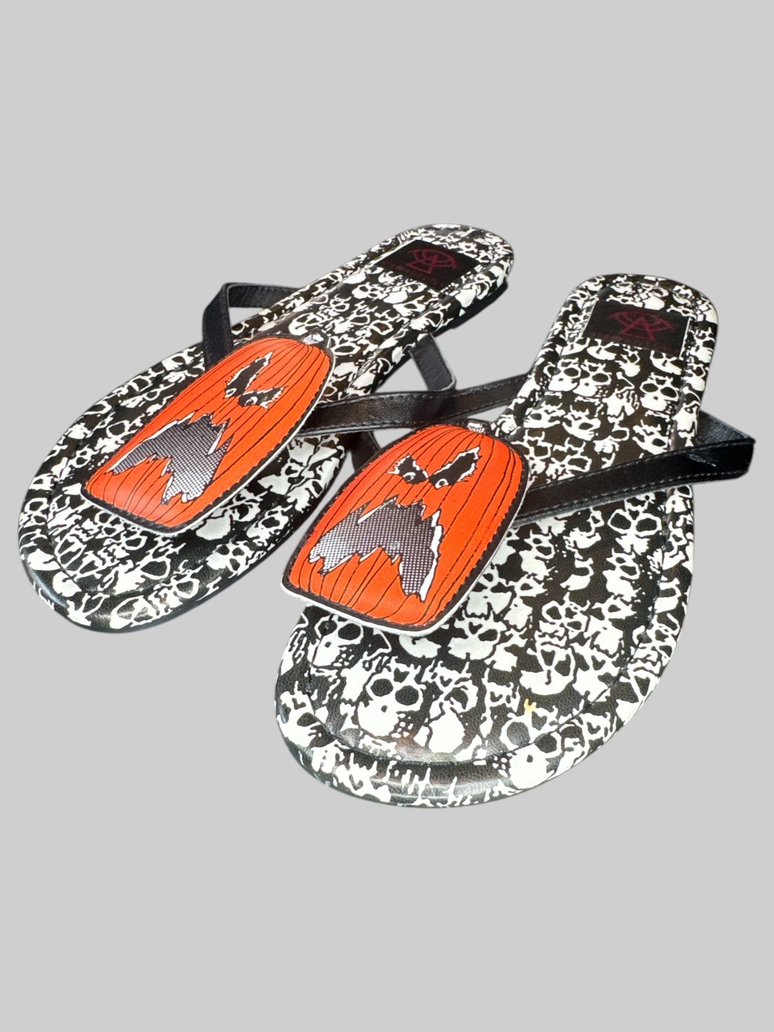 Size 6 Strange Cult pumpkin and skull flip flops