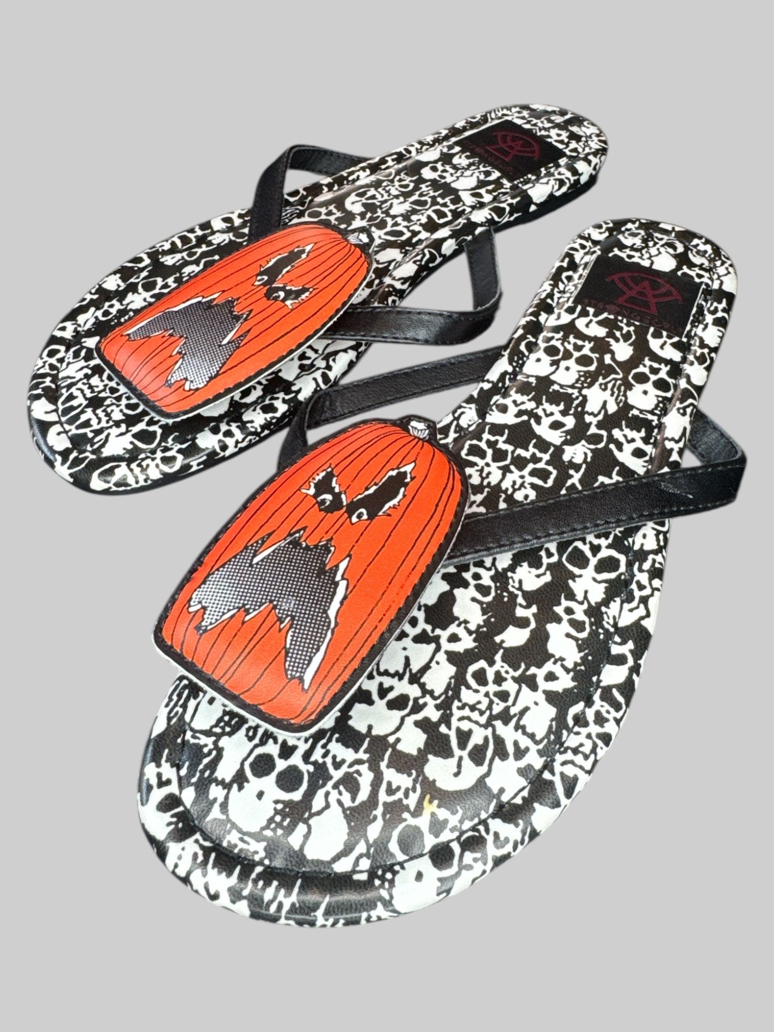 Size 6 Strange Cult pumpkin and skull flip flops