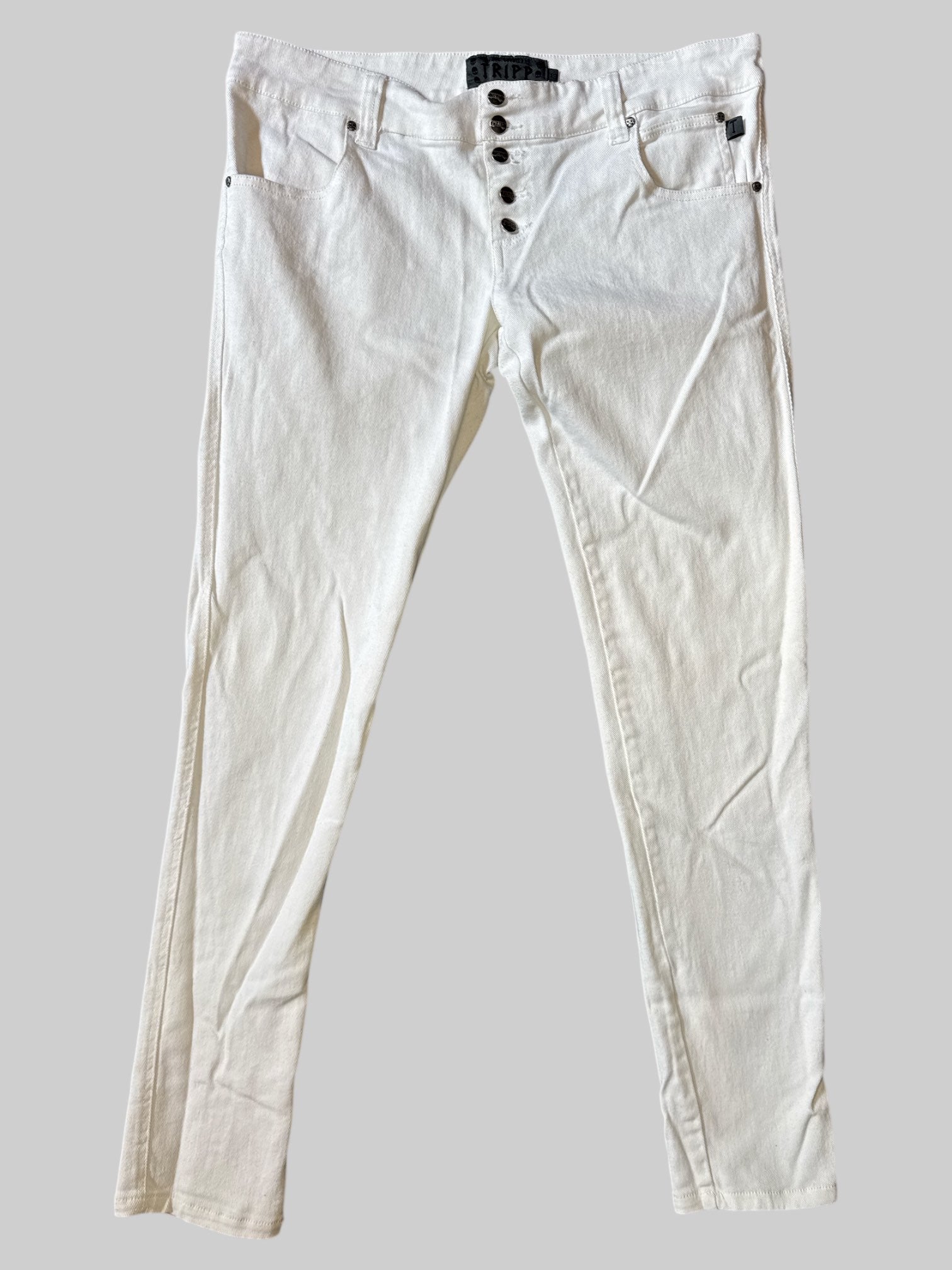 L White Tripp jeans with button closure on front, pockets, metal skull details, and T pockets on back