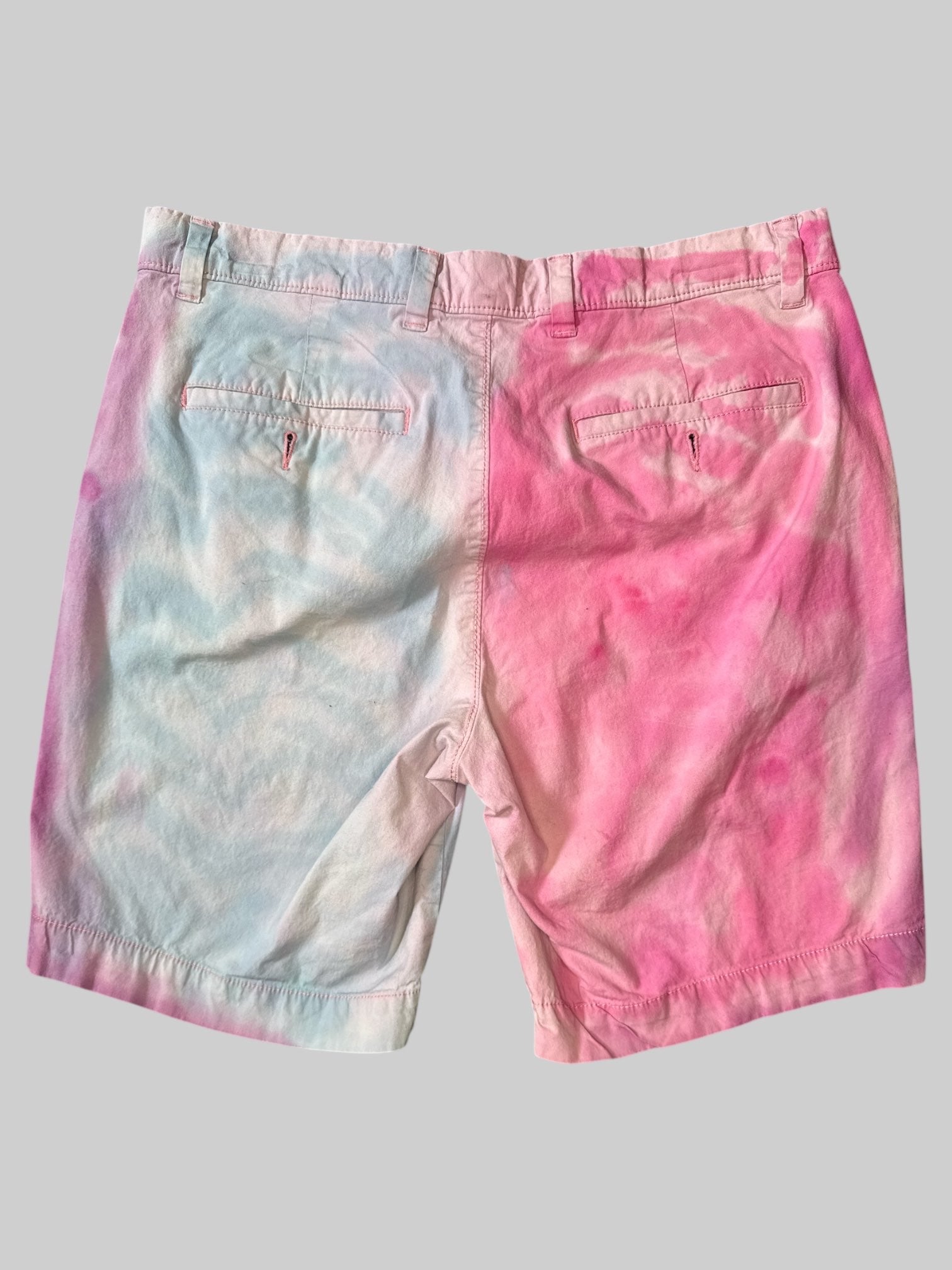L Pink and light blue tie-dye shorts with purple “Pride” graphic on legs
