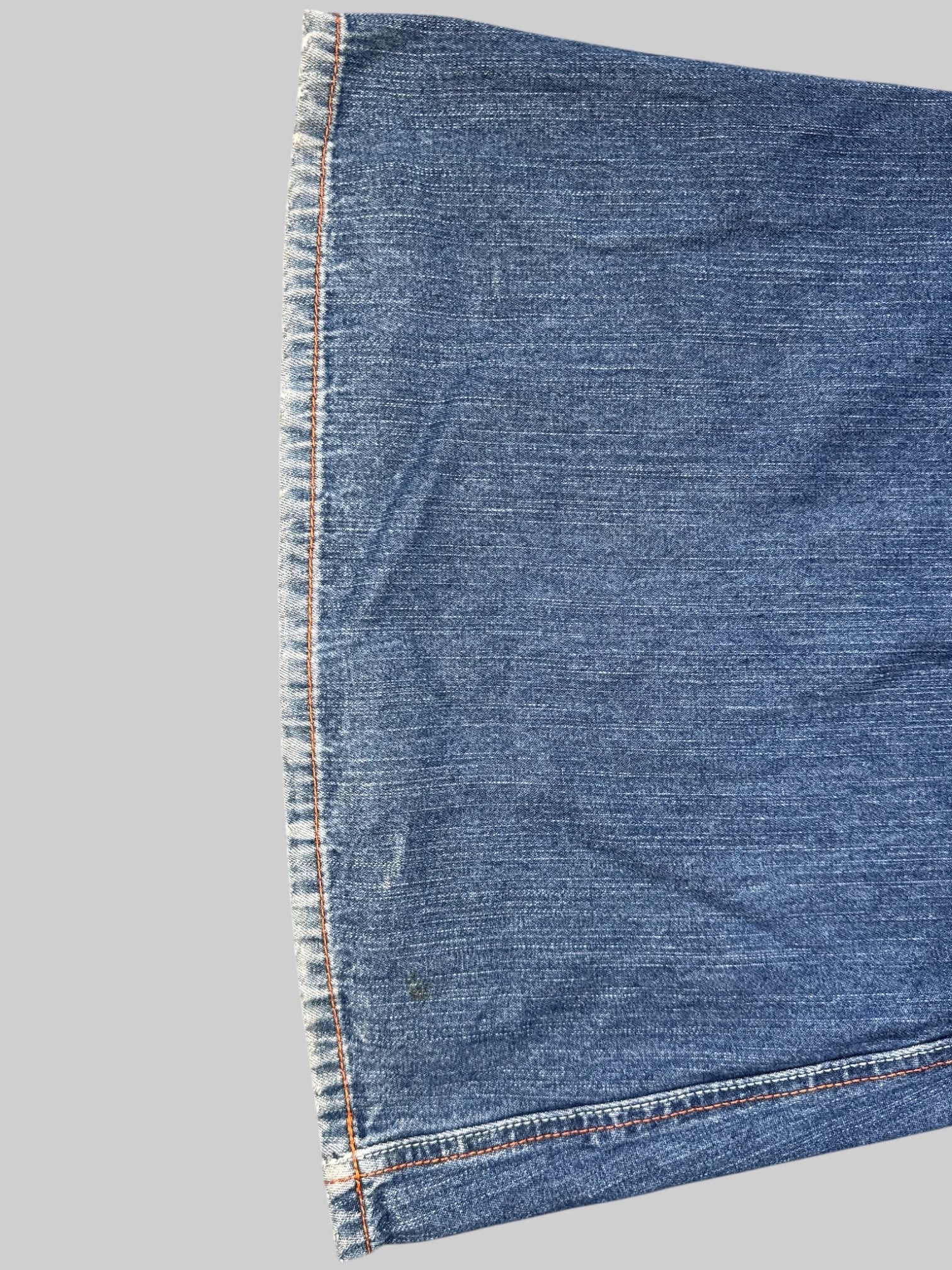 L Vintage blue Kikgirl jeans with orange stitching, flared legs, and large back pockets