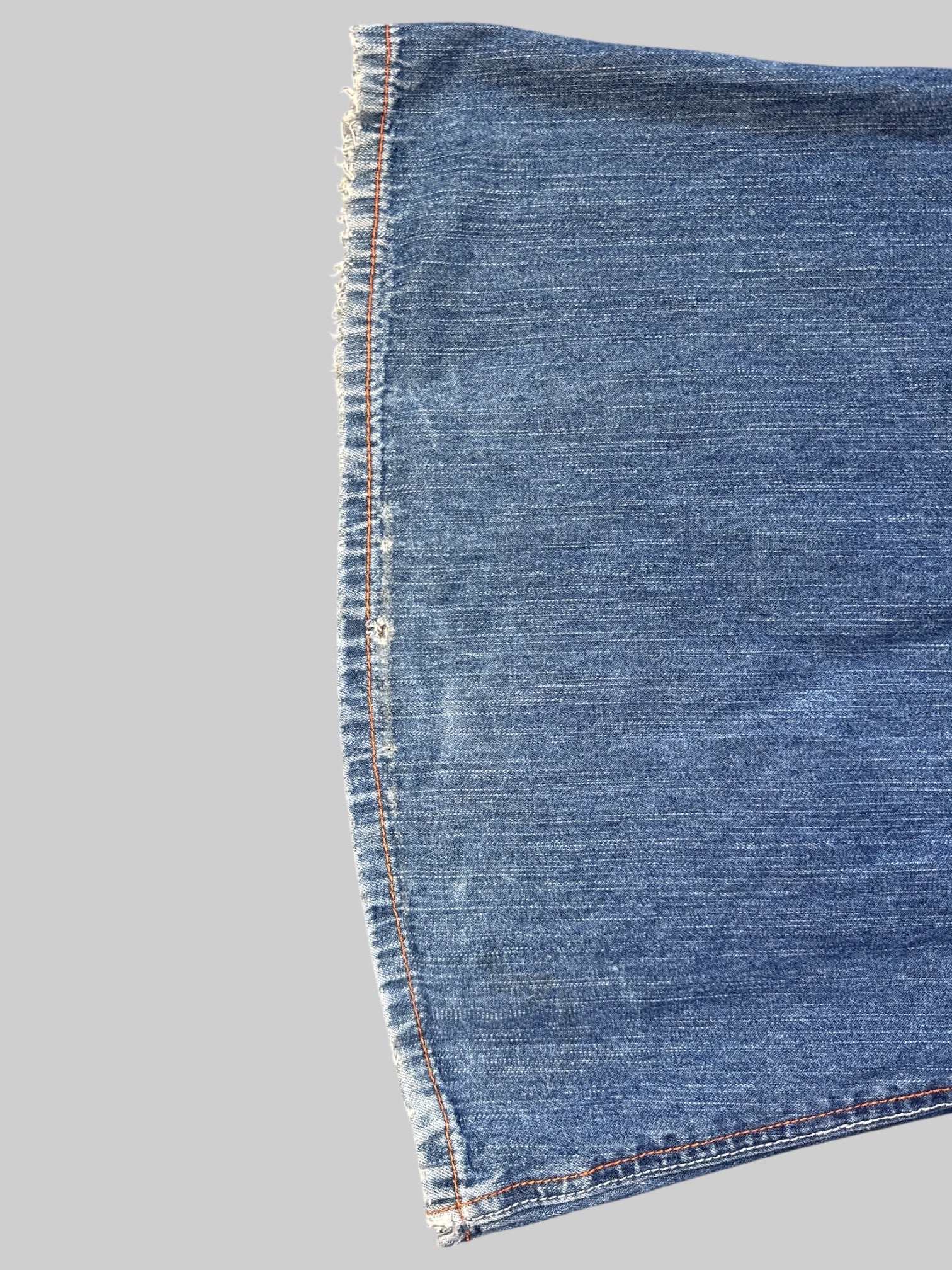 L Vintage blue Kikgirl jeans with orange stitching, flared legs, and large back pockets