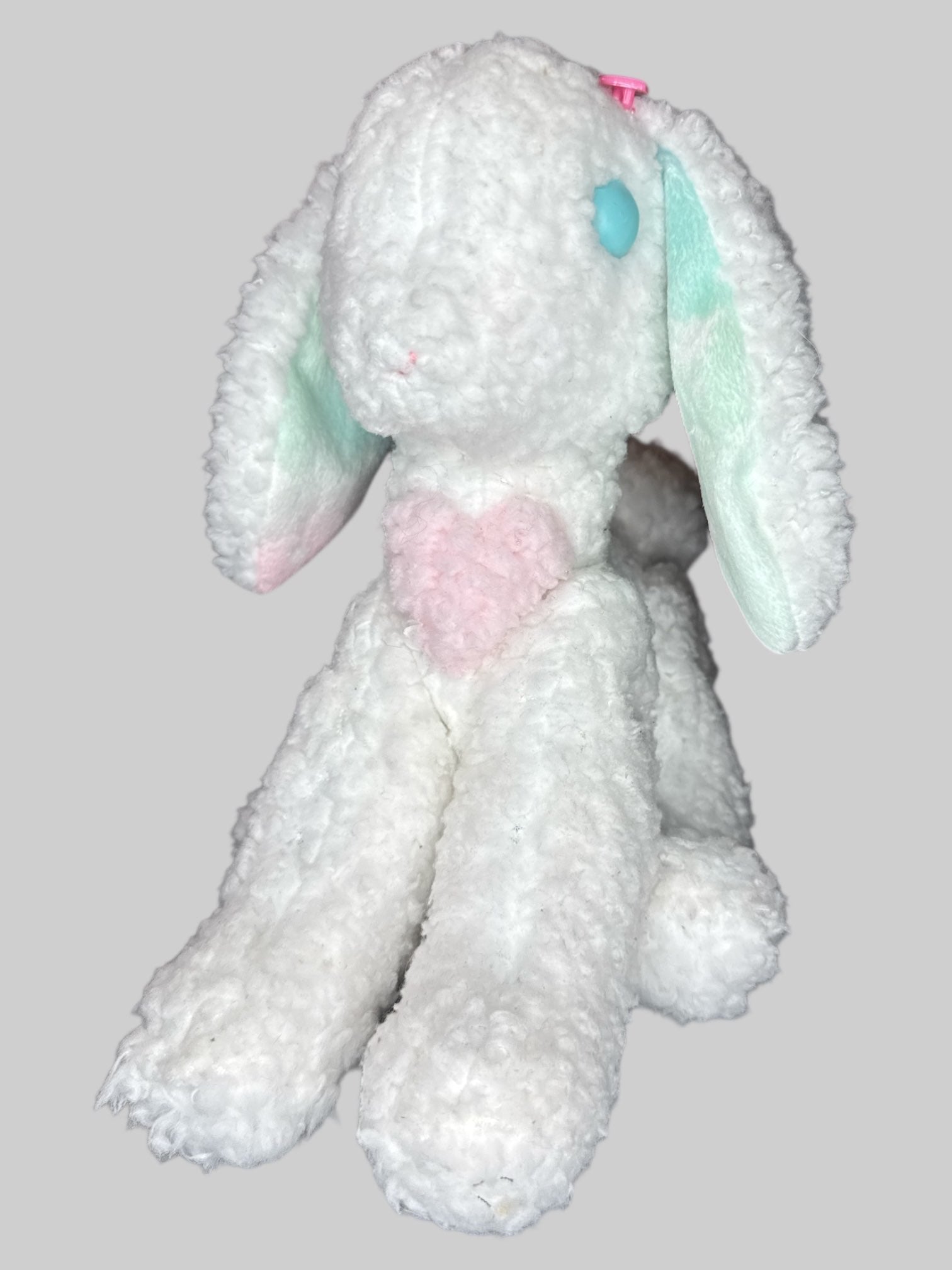 Handmaid white bunny plush with pink heart on chest, blue eyes, and pink hearts near ears