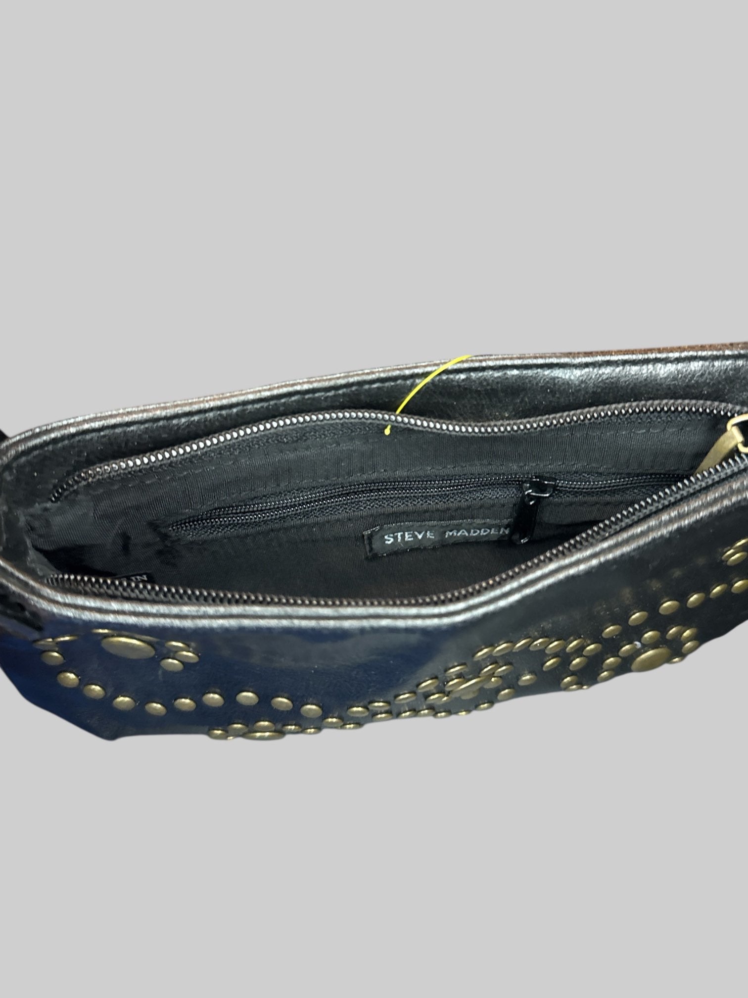Vintage black leather handbag with brass tone studs, and zipper pocket on inside