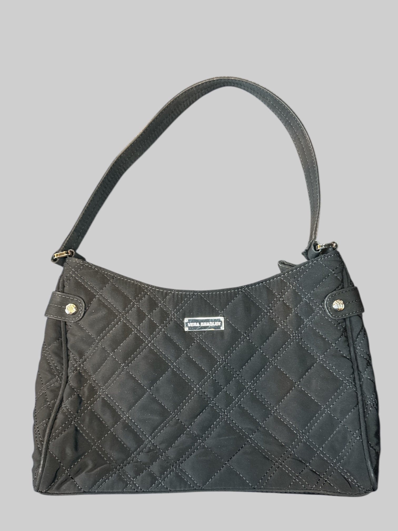 Black quilted bag with magnetic pocket on front, and zipper pocket on inside