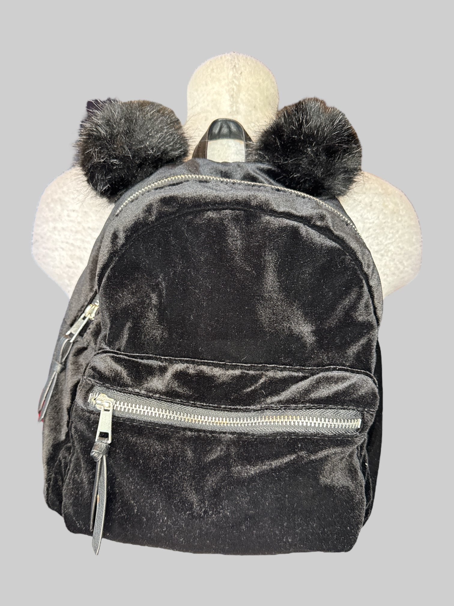 Black velvet small backpack with fuzzy ears on top, and multiple zipper pockets