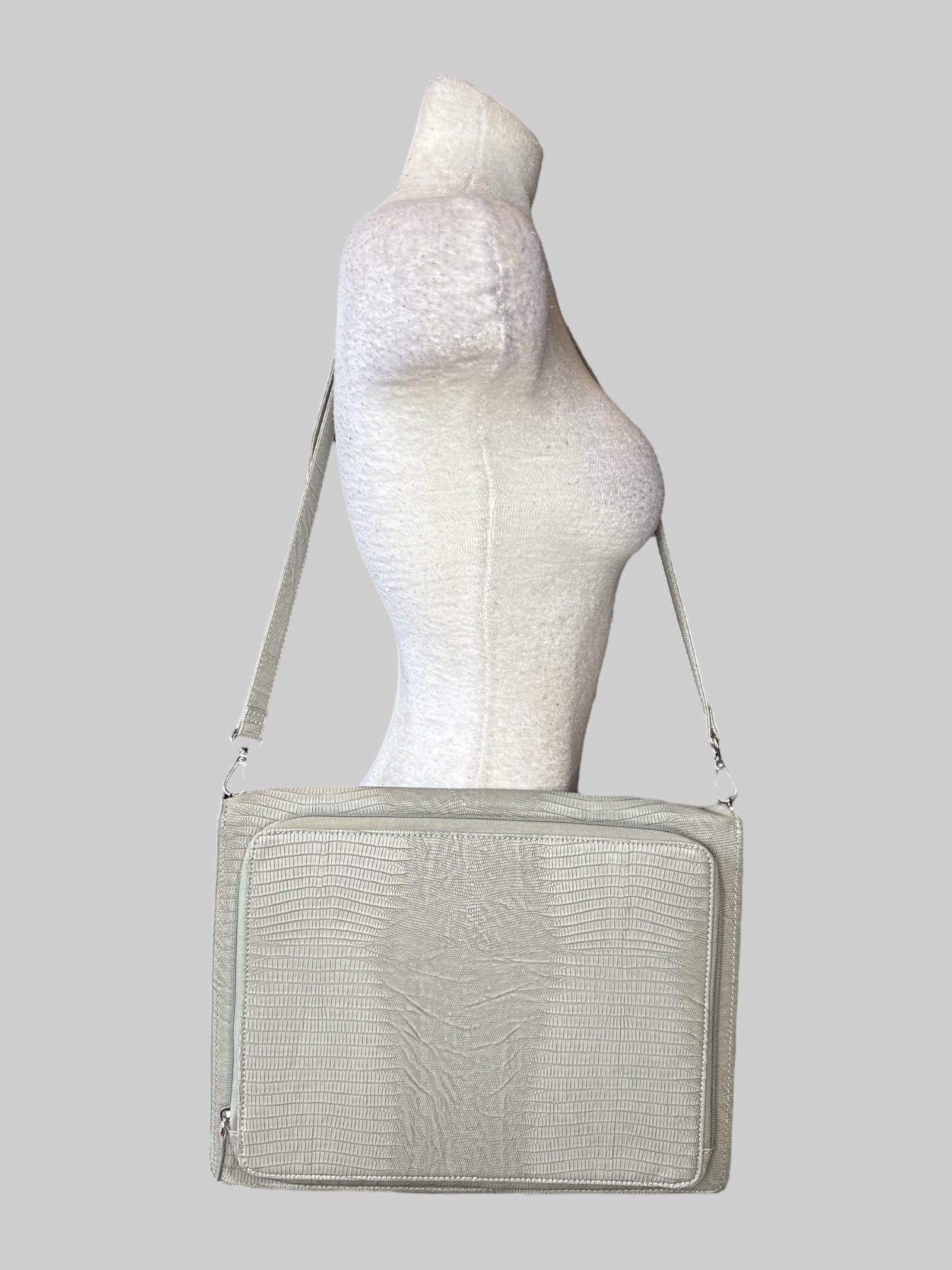 Grey leather laptop bag with shoulder strap, zipper pocket on the outside, and flip pocket