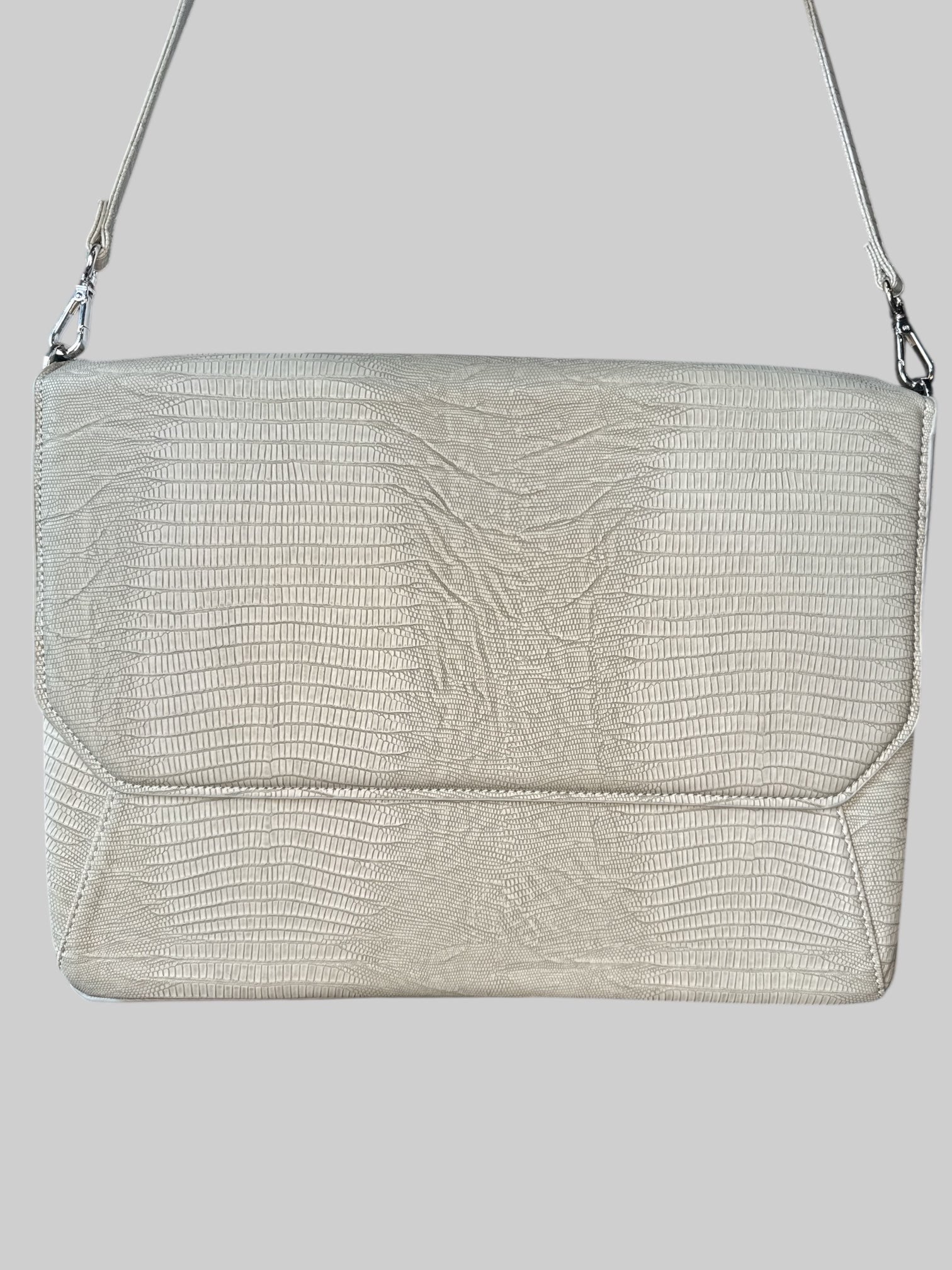 Grey leather laptop bag with shoulder strap, zipper pocket on the outside, and flip pocket
