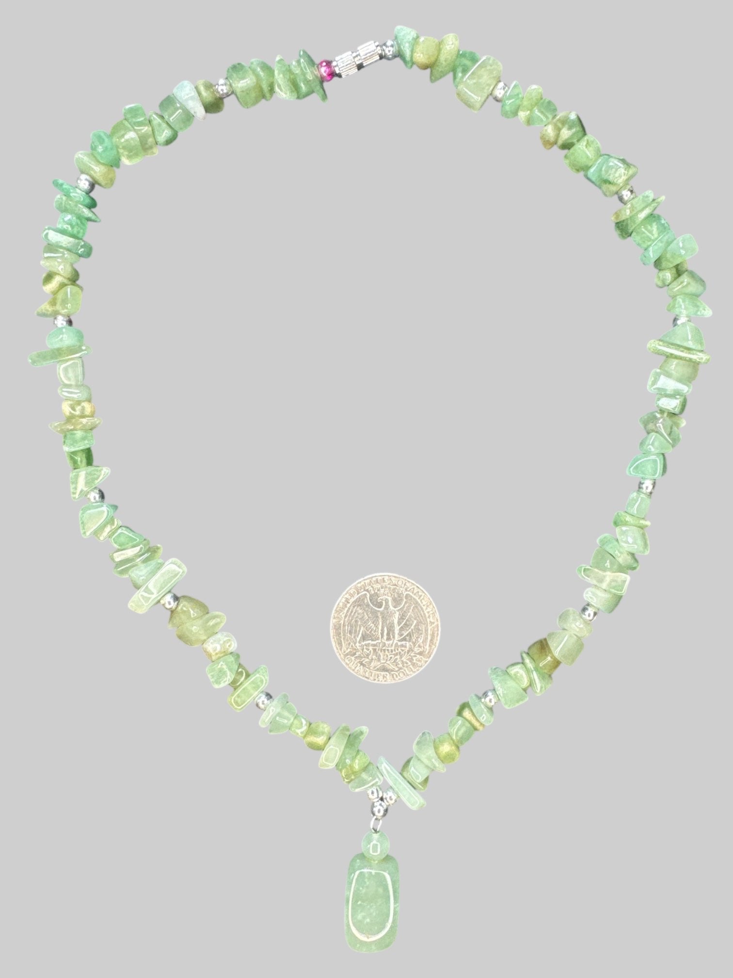 Green shaded necklace with screw, clasp, and small pendant