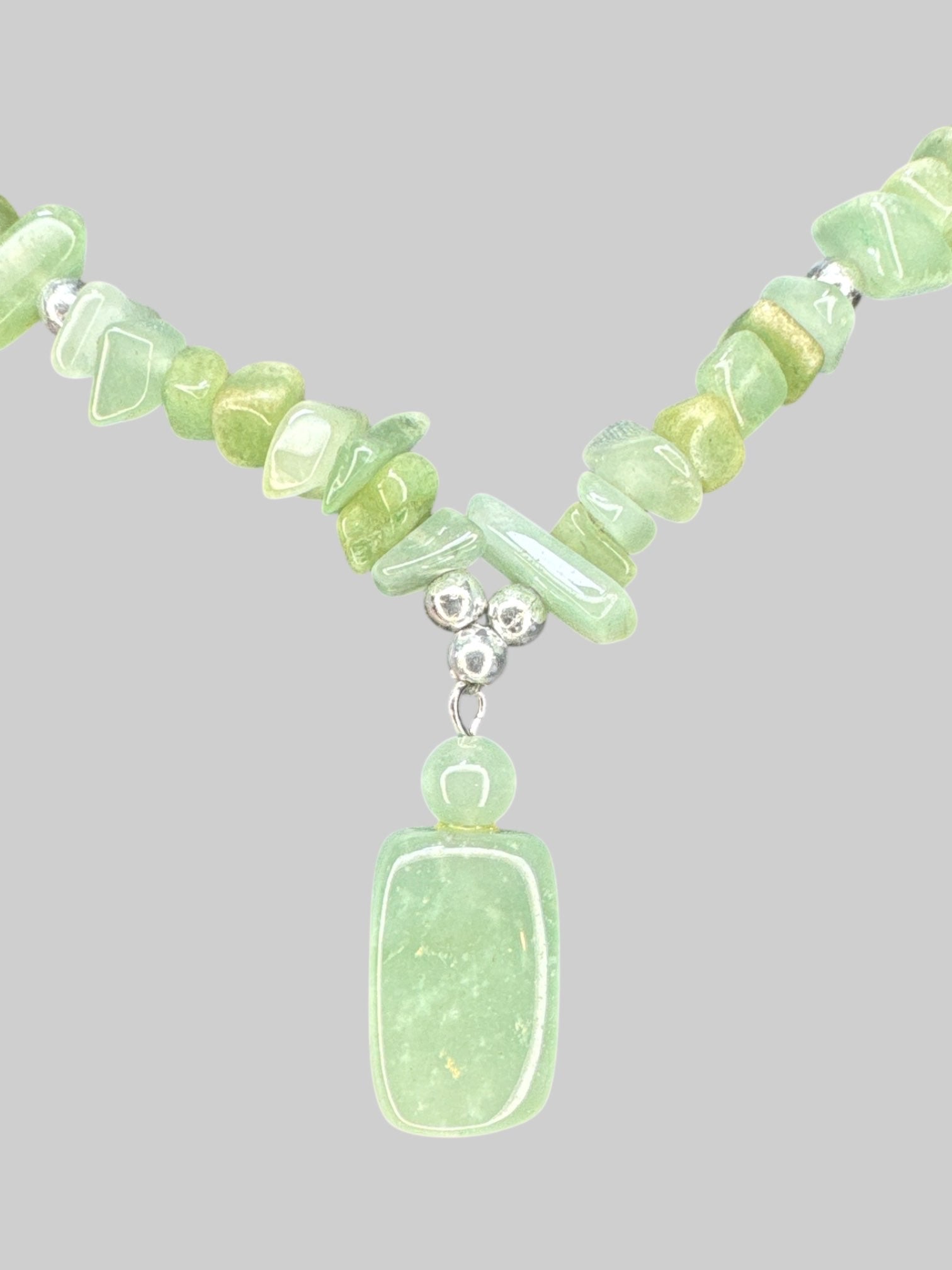 Green shaded necklace with screw, clasp, and small pendant