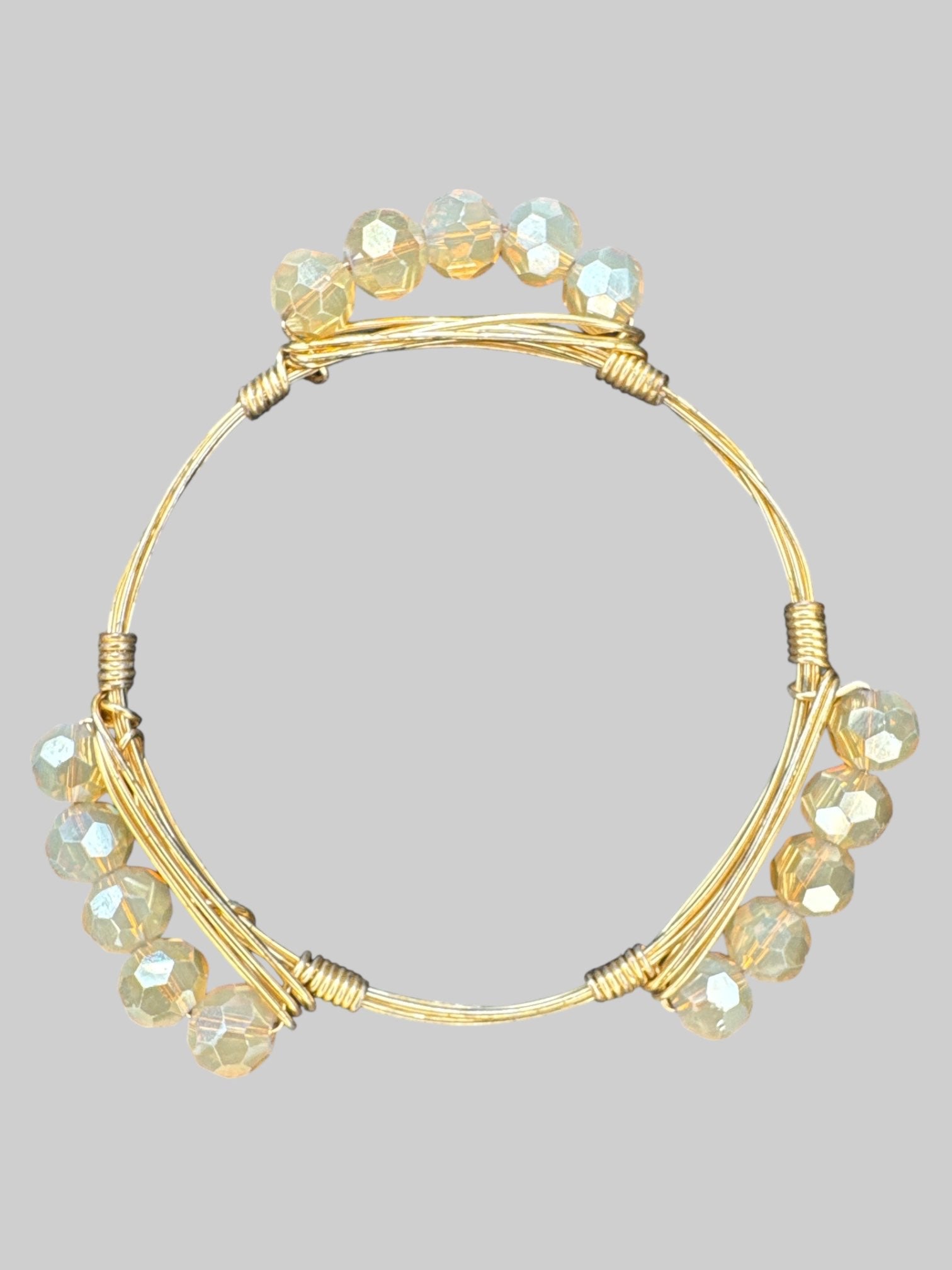 Gold tone wire wrapped bracelet with smoky colored beats