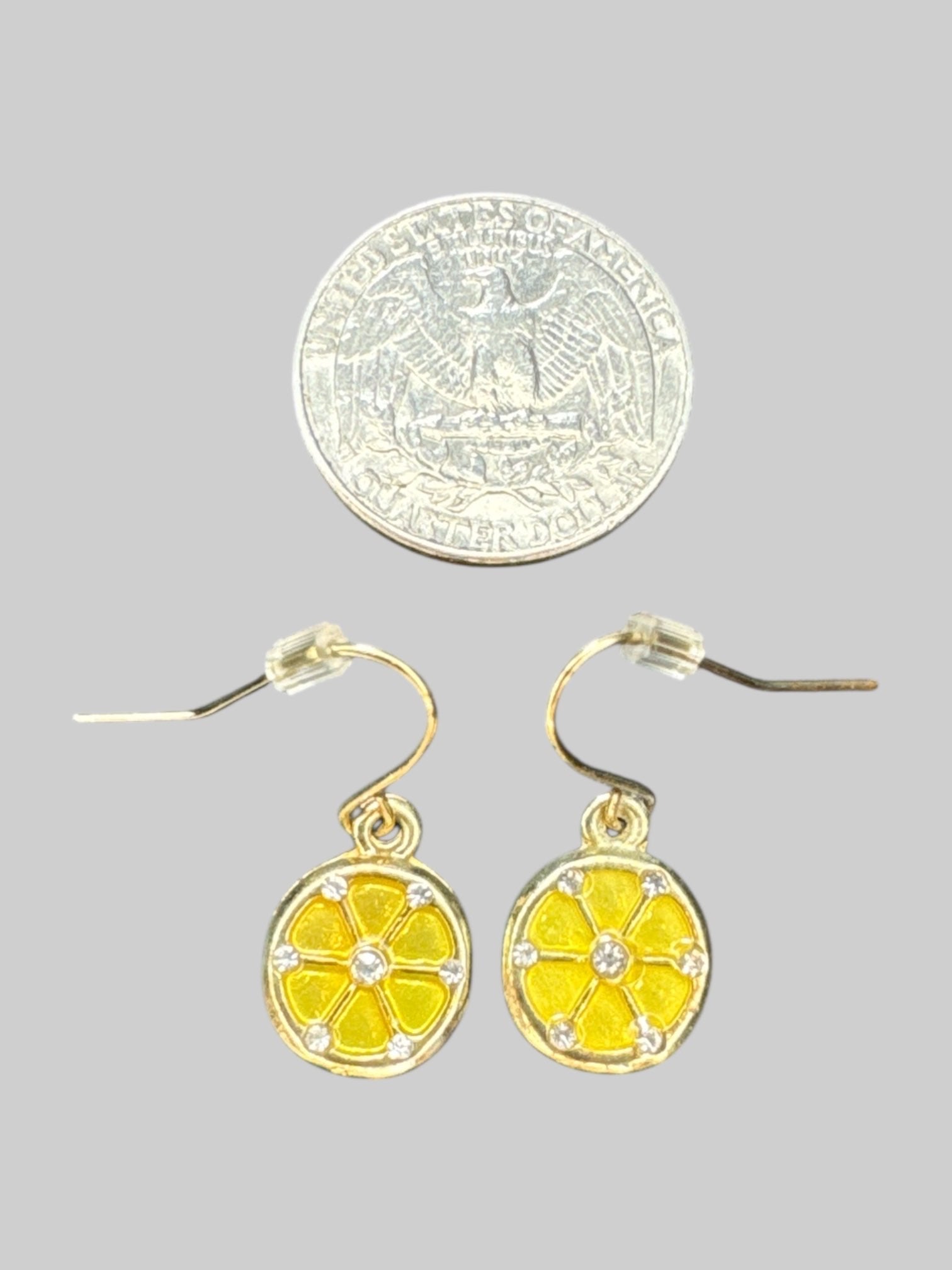 Gold tone lemon slice dangly earrings