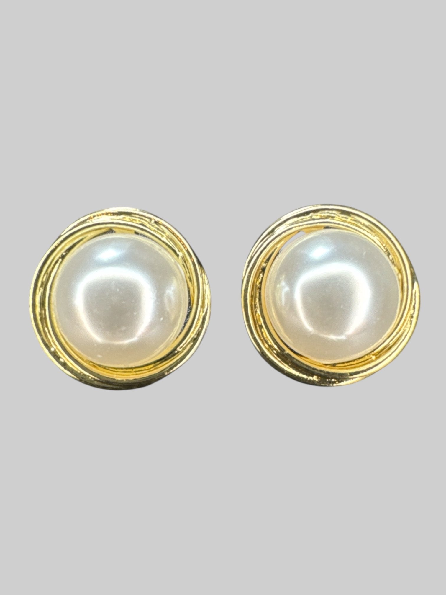 Gold tone stud earrings with large faux pearl