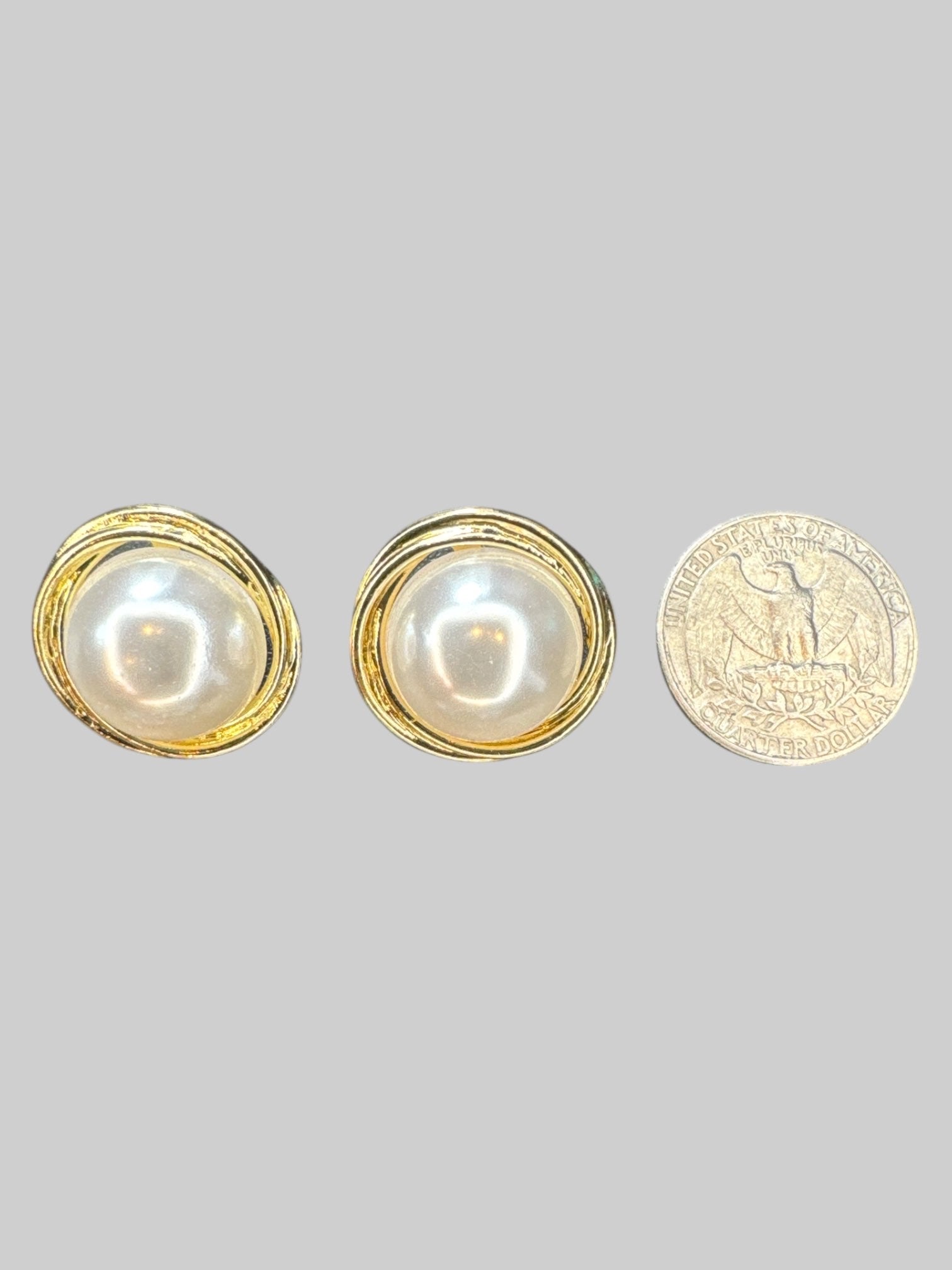 Gold tone stud earrings with large faux pearl