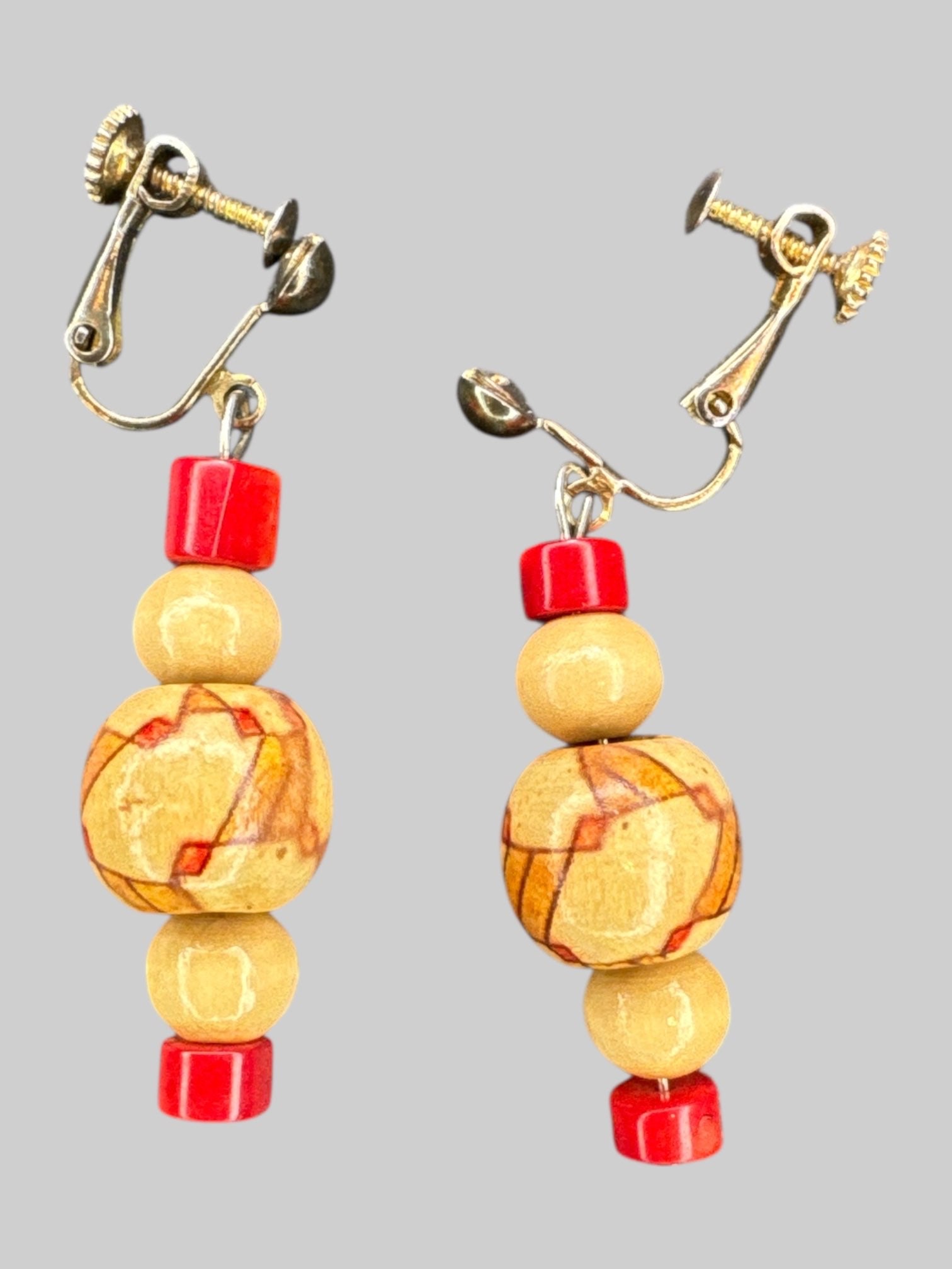 Screw clip on dangly earrings with geometric designed wooden beads