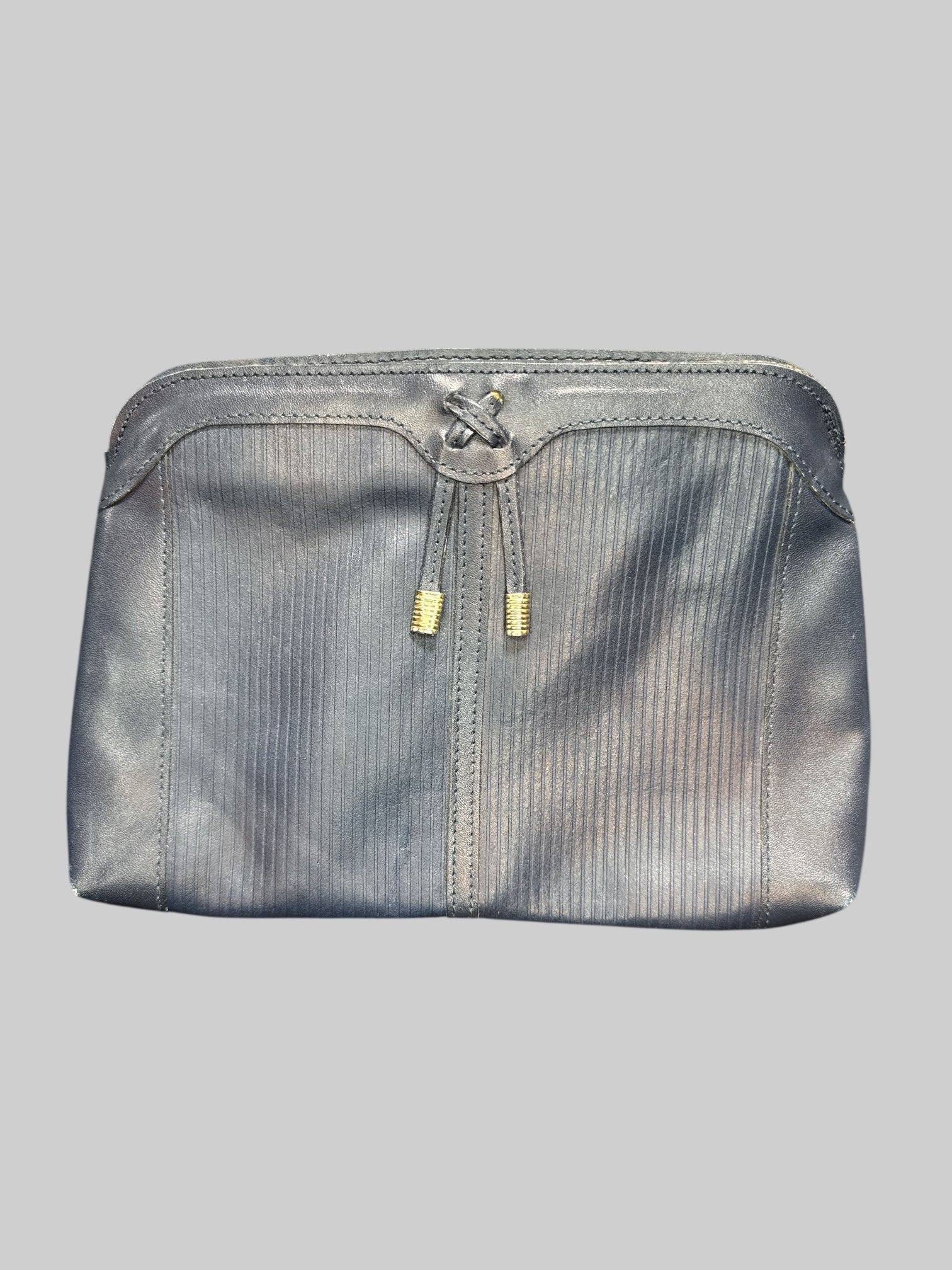 Blue leather handbag with faux drawstring on front, multiple zipper pockets, and hooks for shoulder strap