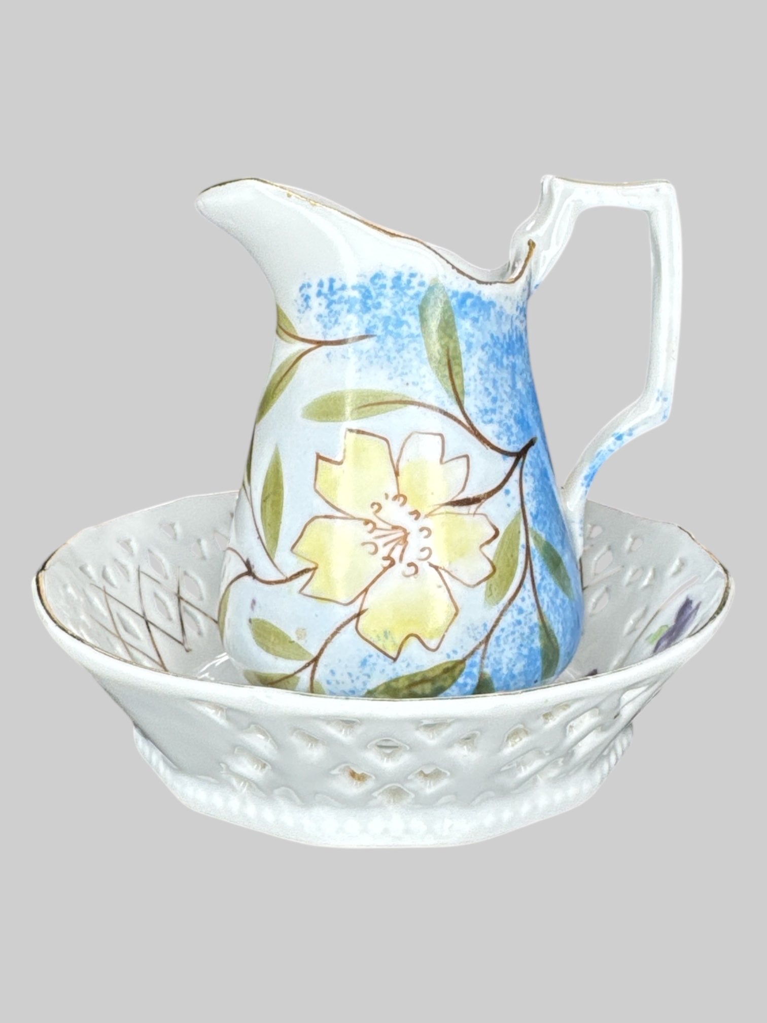 Small ceramic pitcher and plate with different color floral designs