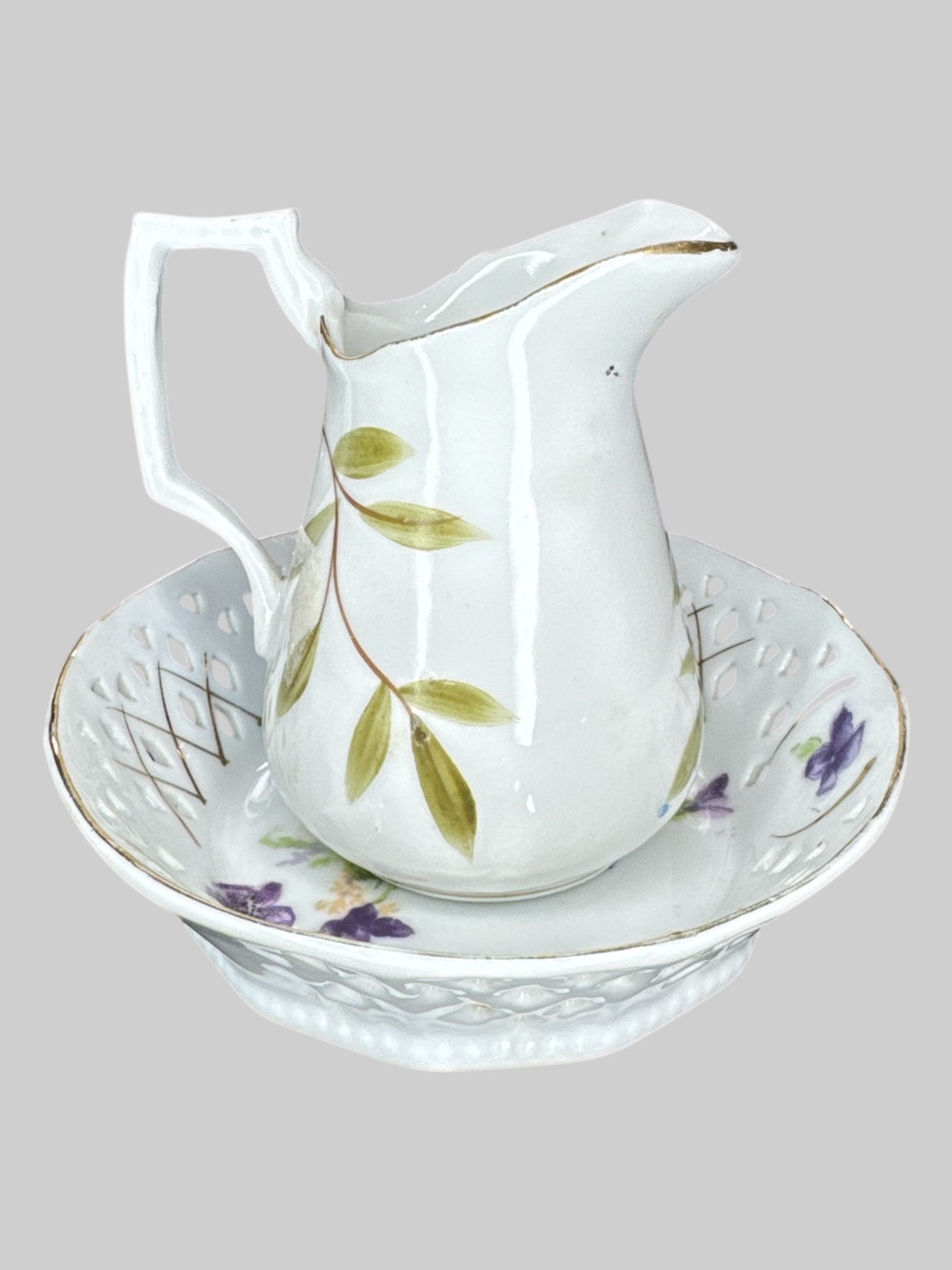 Small ceramic pitcher and plate with different color floral designs