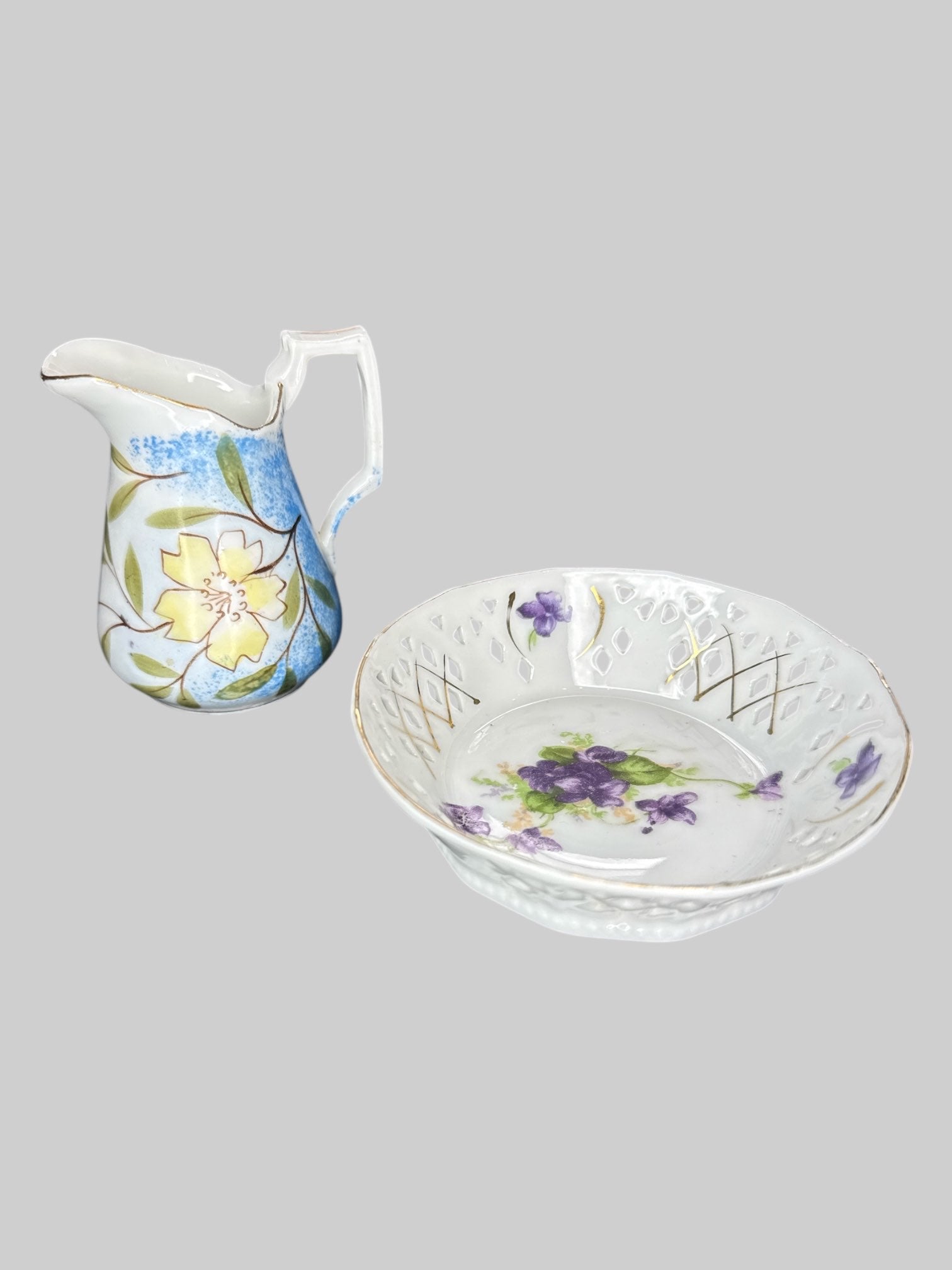 Small ceramic pitcher and plate with different color floral designs