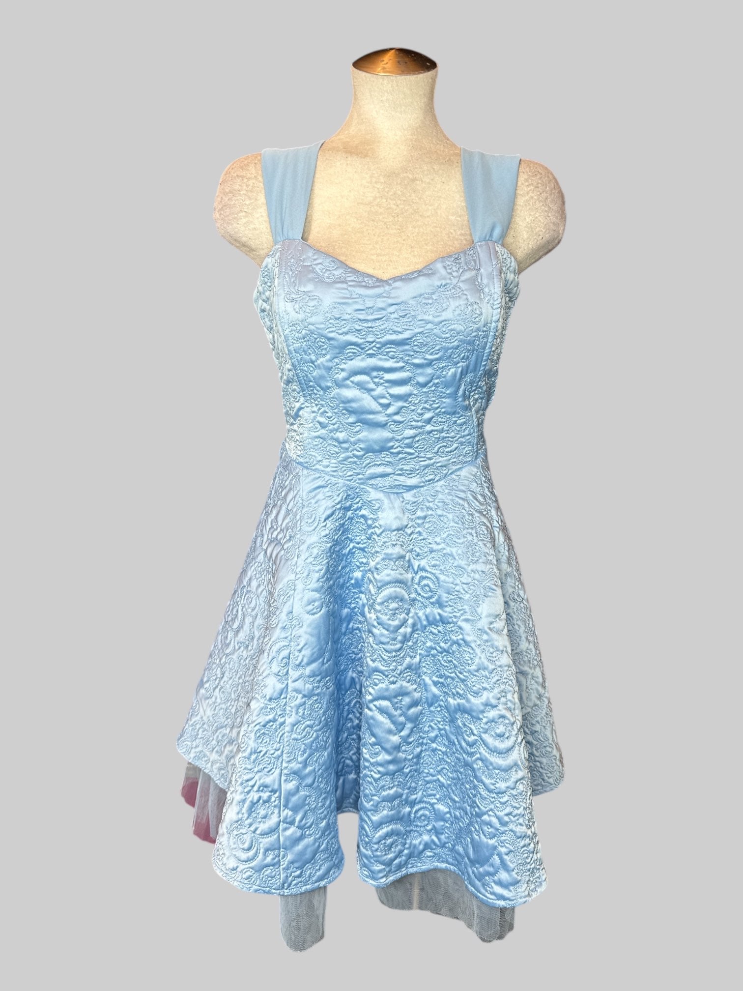 L Light blue sleeveless dress with metallic or Nate stitching all over, lacing on back, and zipper on side