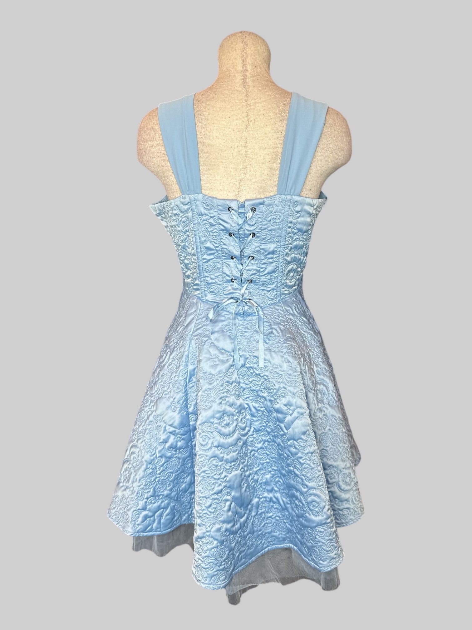 L Light blue sleeveless dress with metallic or Nate stitching all over, lacing on back, and zipper on side