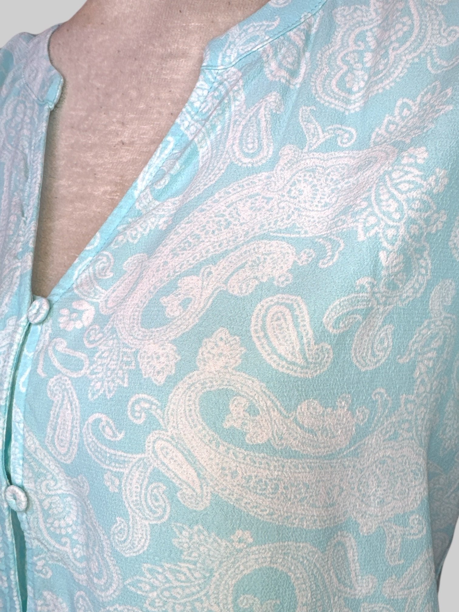 M Light blue top with white paisley pattern, buttons, and pleated sleeves