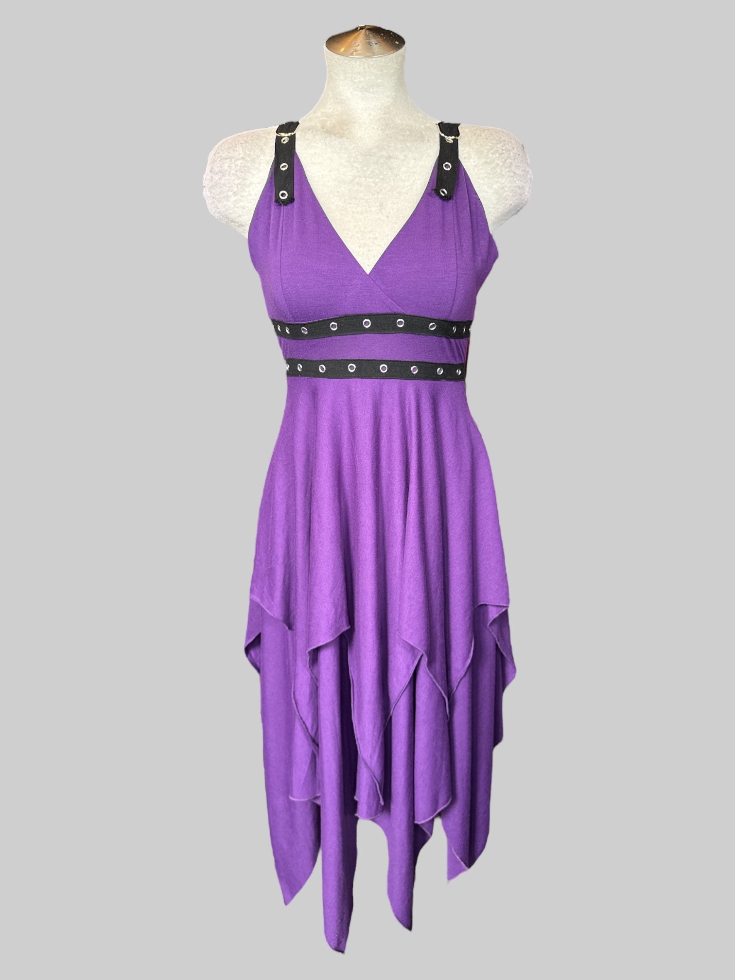 Purple sleeveless dress with layered design, asymmetrical hem, black canvas material with metal eyelets, and zipper on side