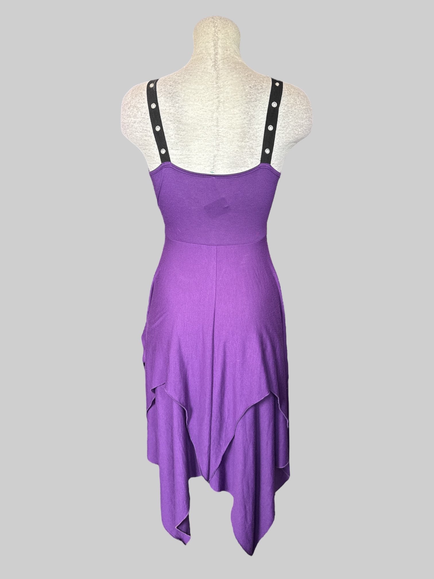 Purple sleeveless dress with layered design, asymmetrical hem, black canvas material with metal eyelets, and zipper on side