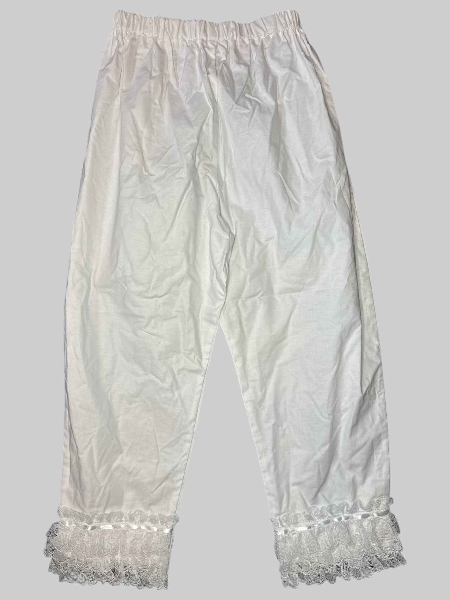 M White stretchy pants with lace layers on bottom hem