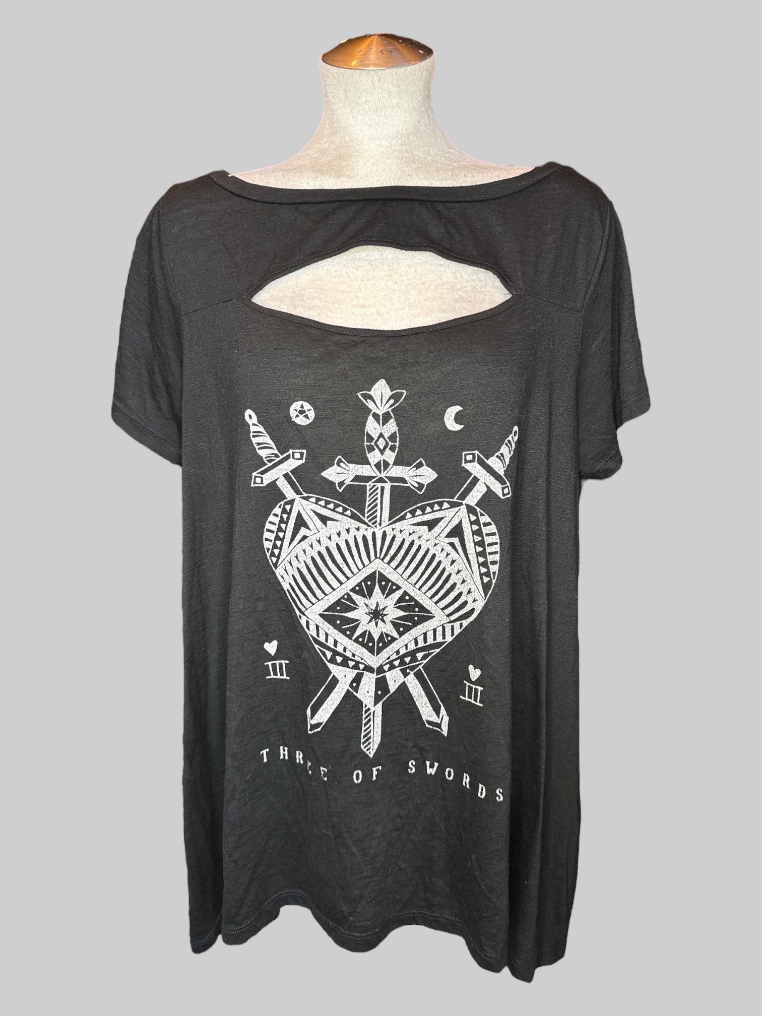 2X Black short sleeve top with cut out on chest, and “three of swords” graphic