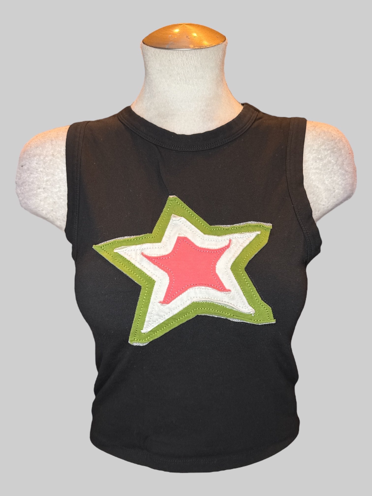 L Black sleeveless top with green white and pink star patch