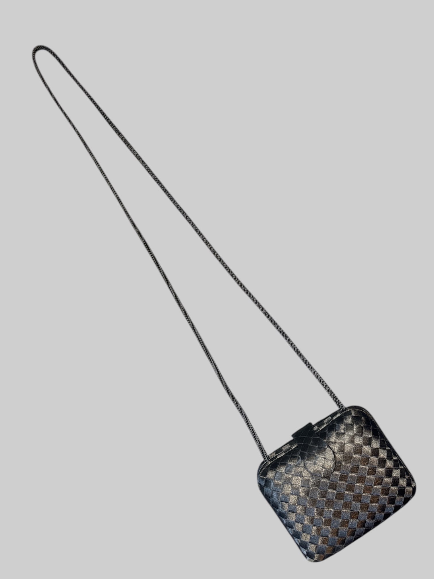 Vintage black woven purse with braided shoulder strap, snap button claspe, and multiple pockets