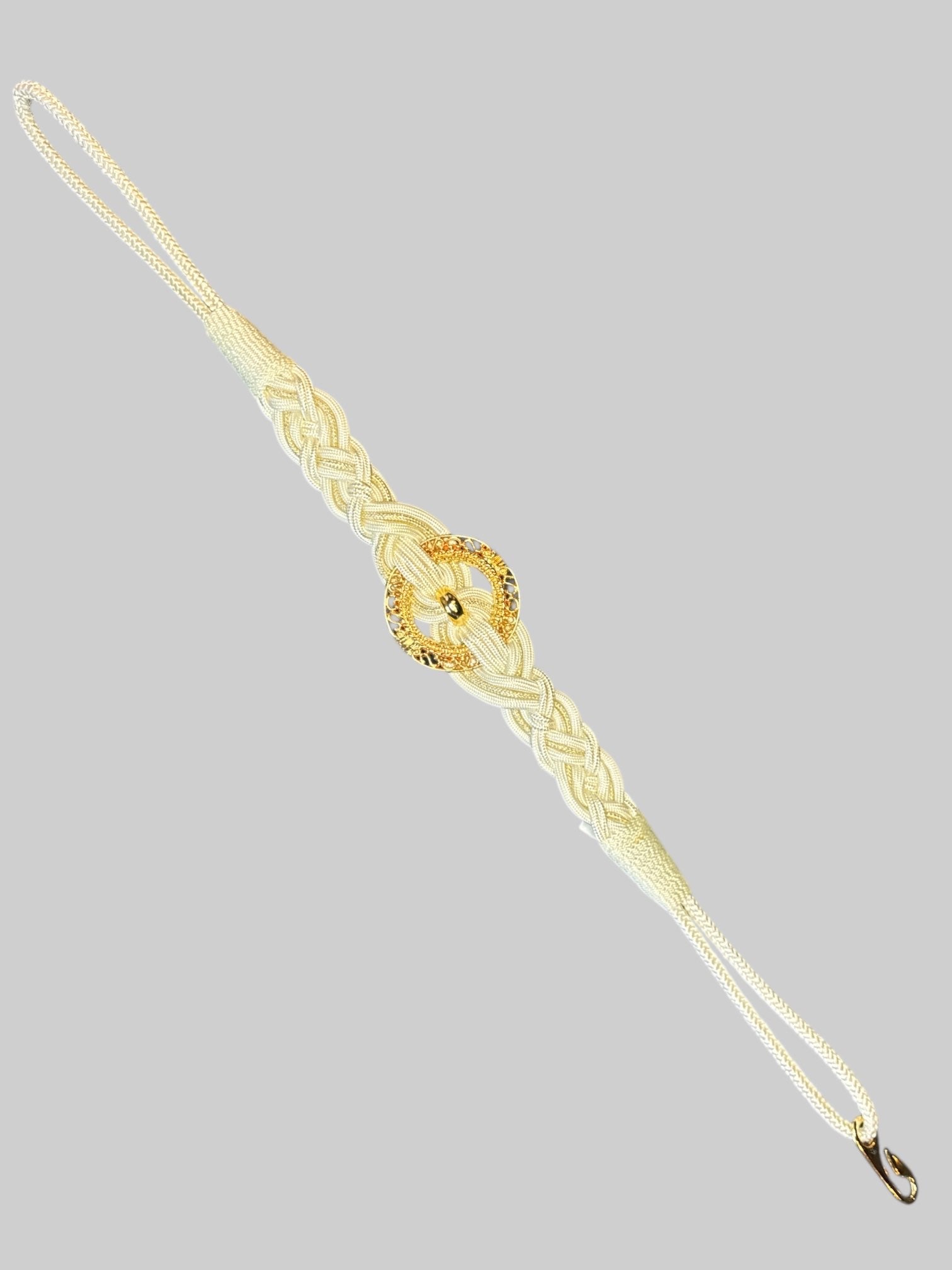 White braided belt with gold tone circle pendant, and hook clasp