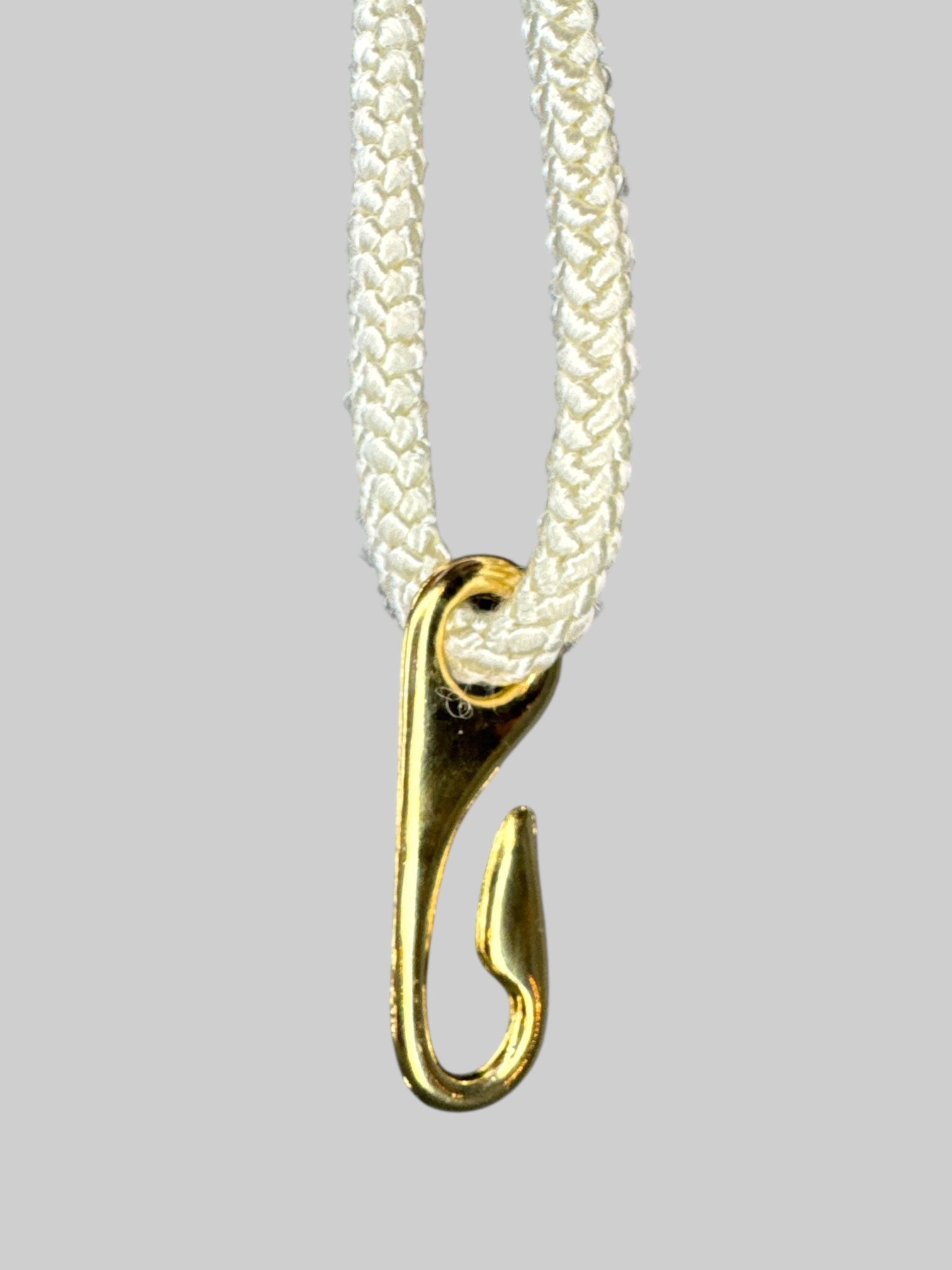 White braided belt with gold tone circle pendant, and hook clasp
