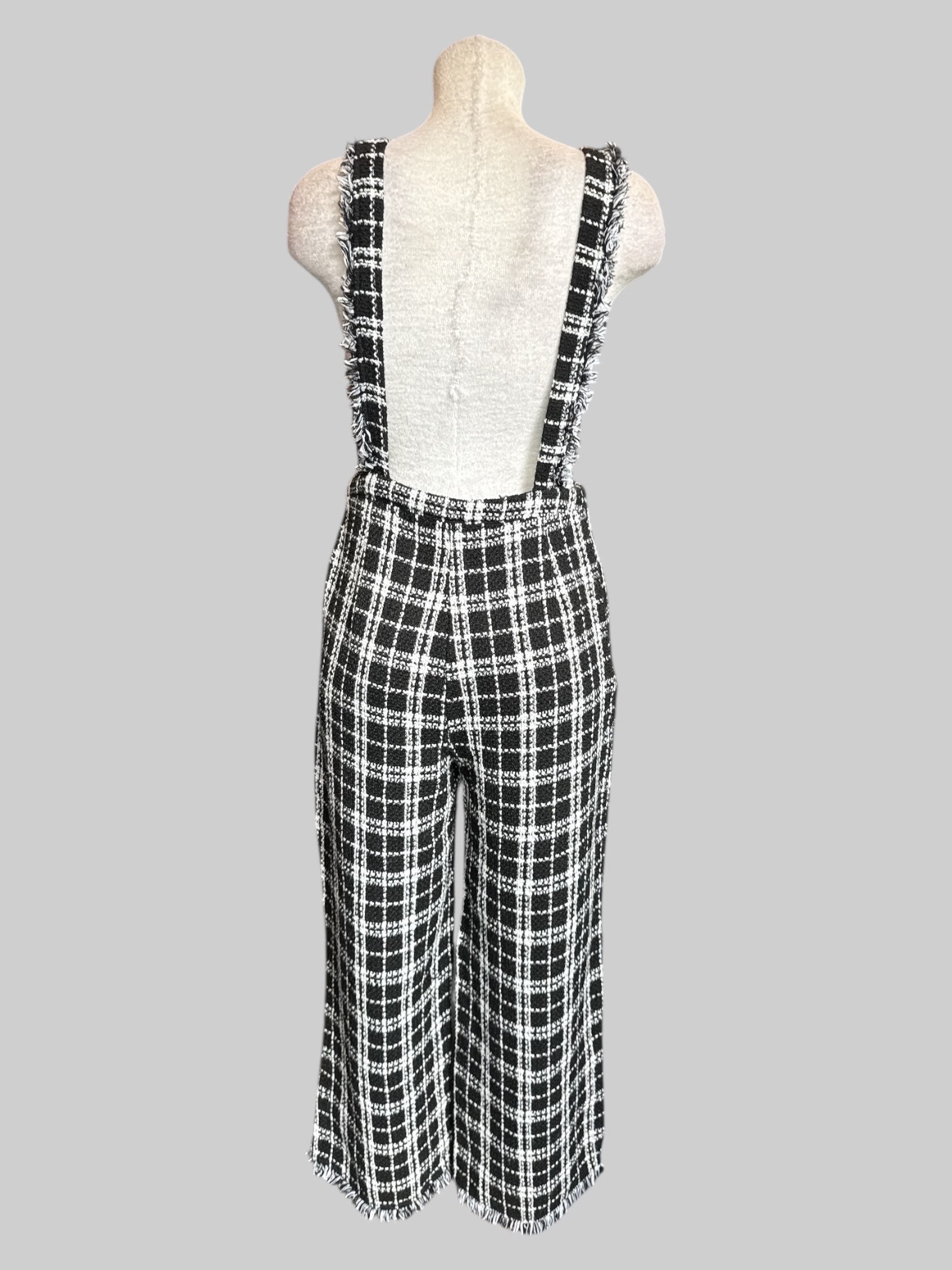 M Black and white plaid jumper with fringe on straps and bottom of pants