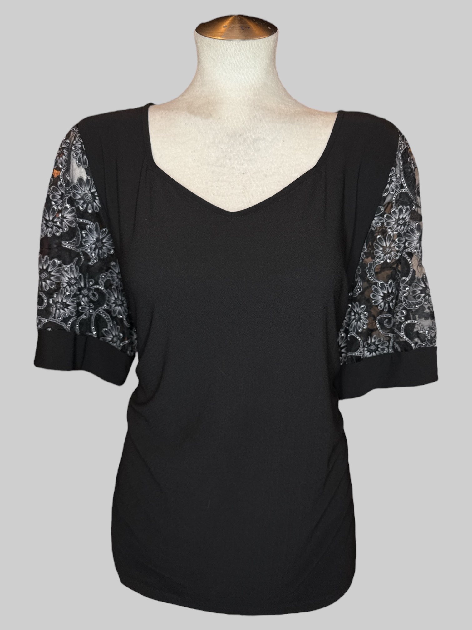 4X Black V-neck top with sheer sleeves with black, gray, and silver florals