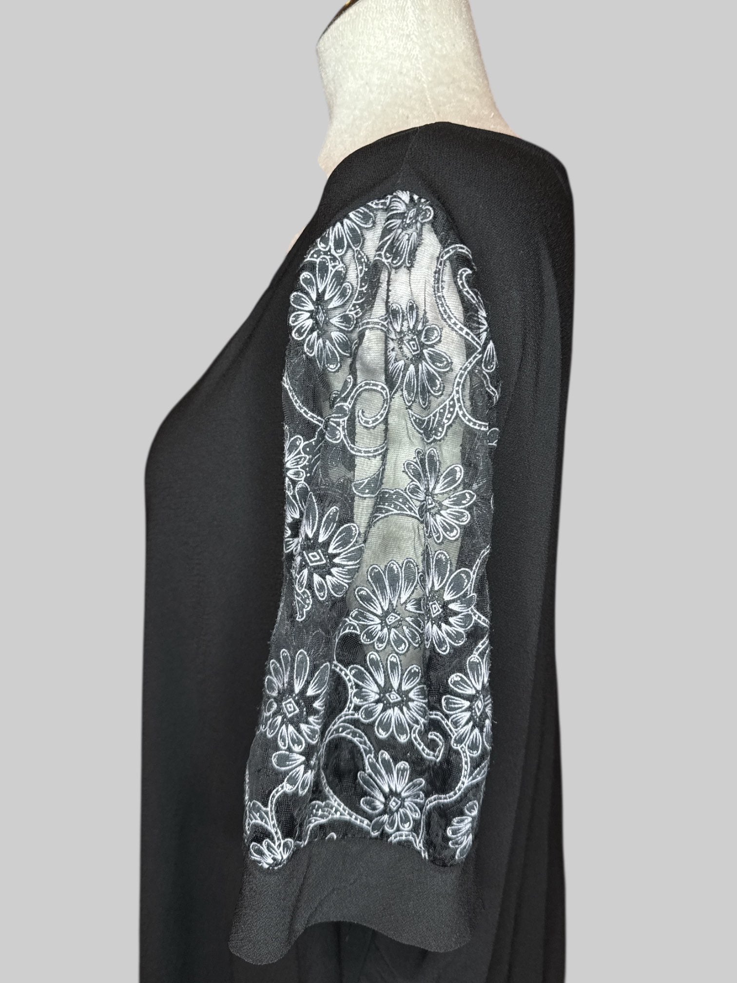 4X Black V-neck top with sheer sleeves with black, gray, and silver florals