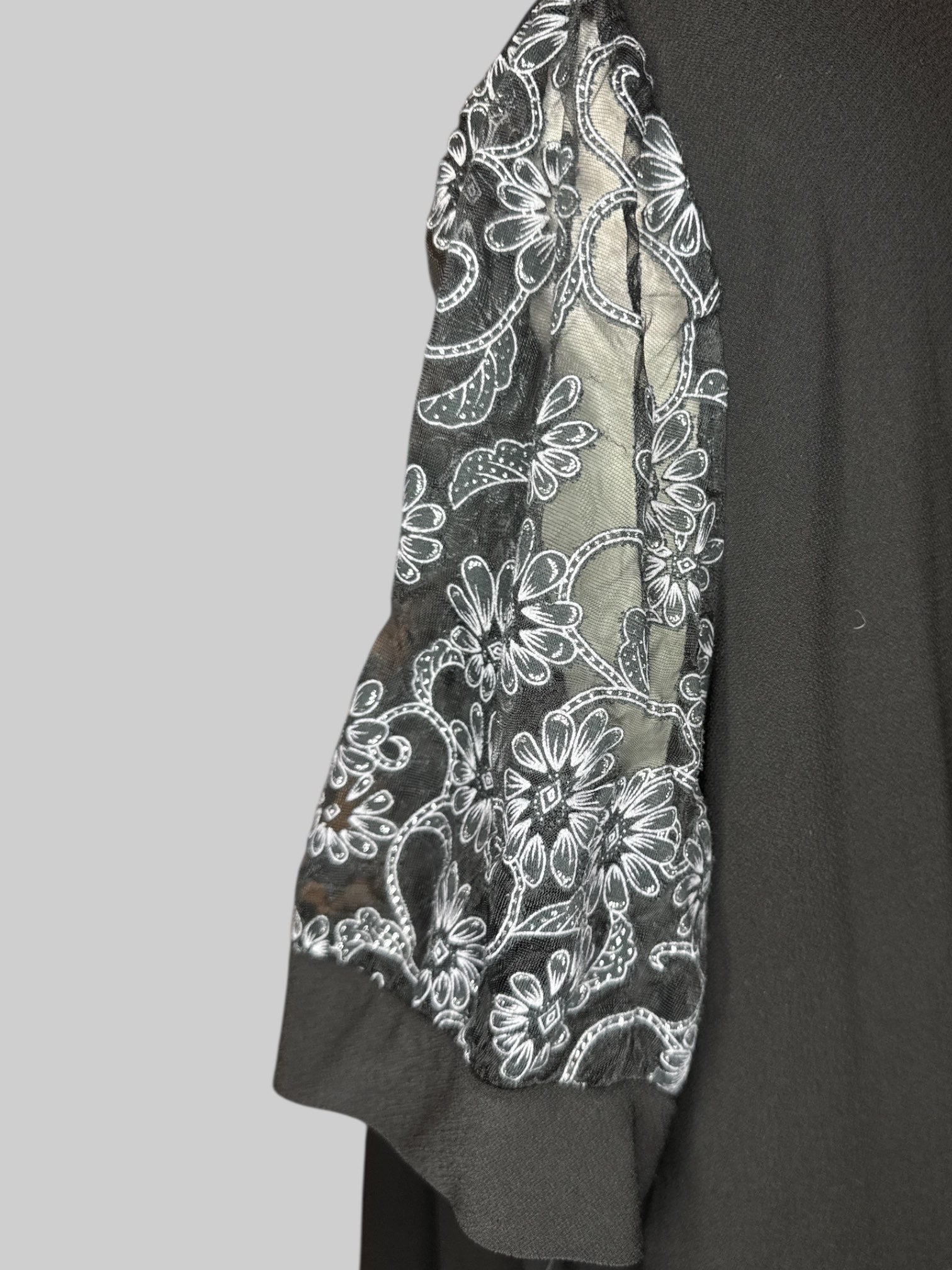 4X Black V-neck top with sheer sleeves with black, gray, and silver florals
