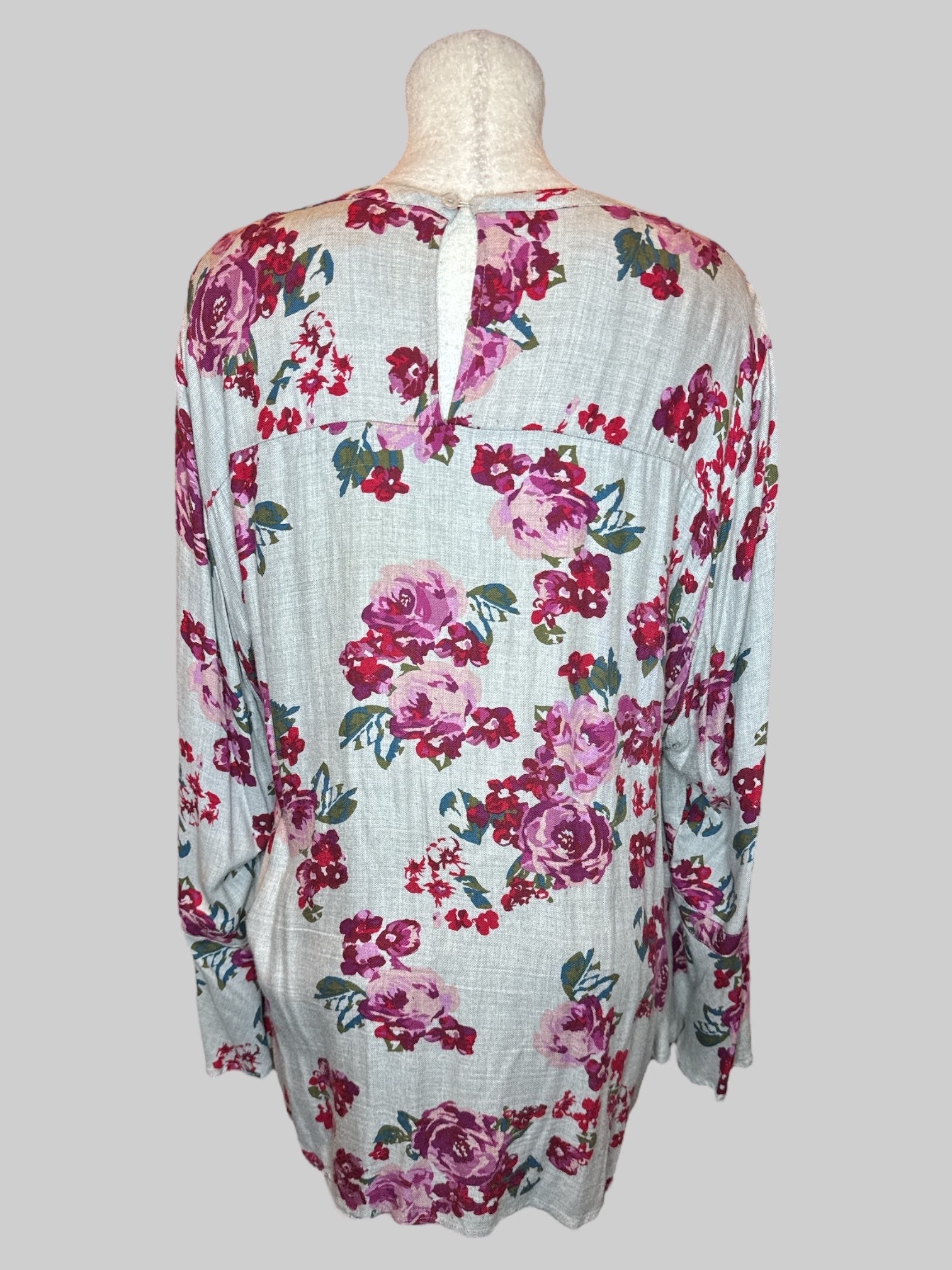 5X Grey long sleeve top with purple red green and blue florals, chest cut out, keyhole back, and flowy sleeves