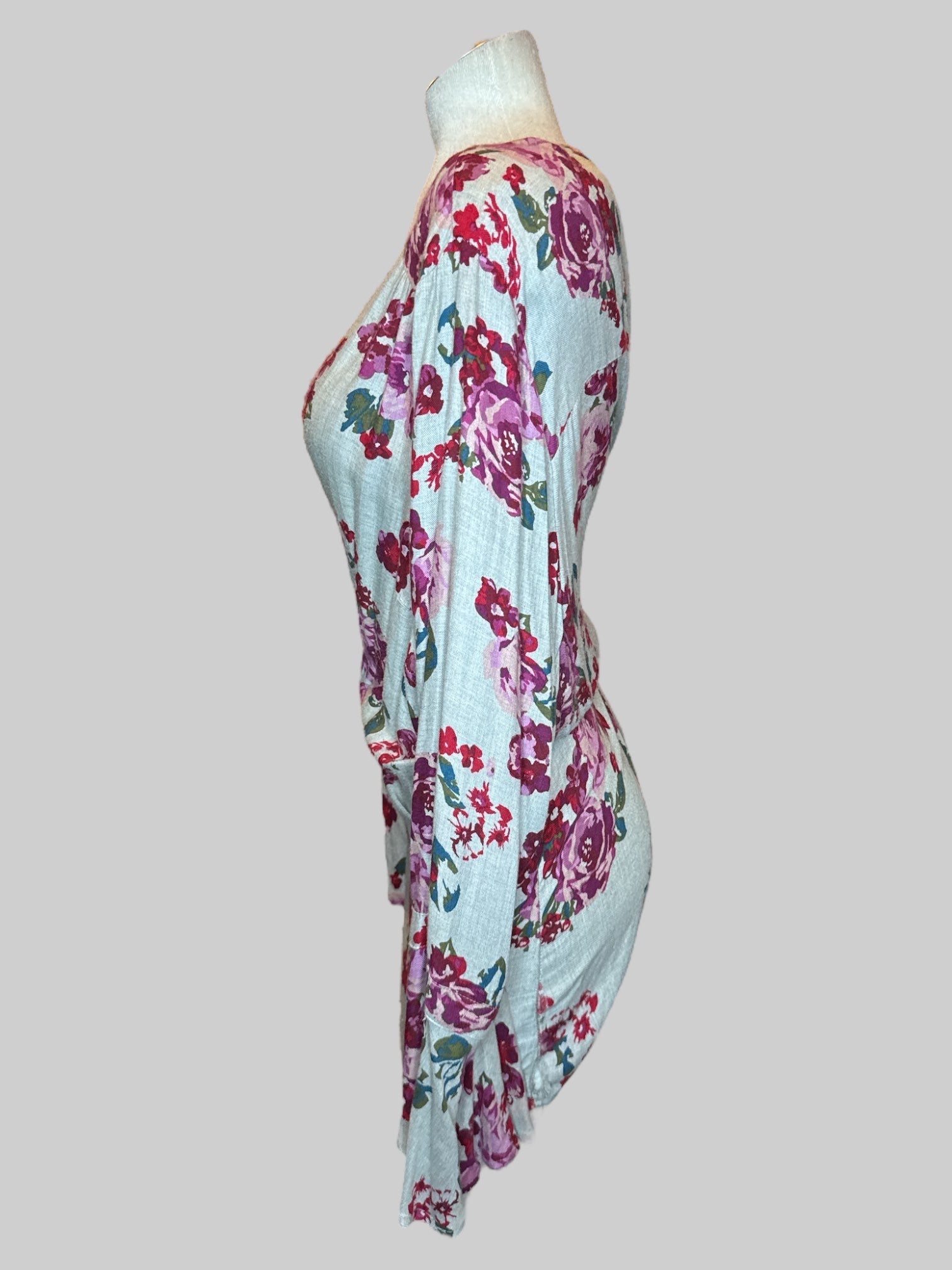 5X Grey long sleeve top with purple red green and blue florals, chest cut out, keyhole back, and flowy sleeves