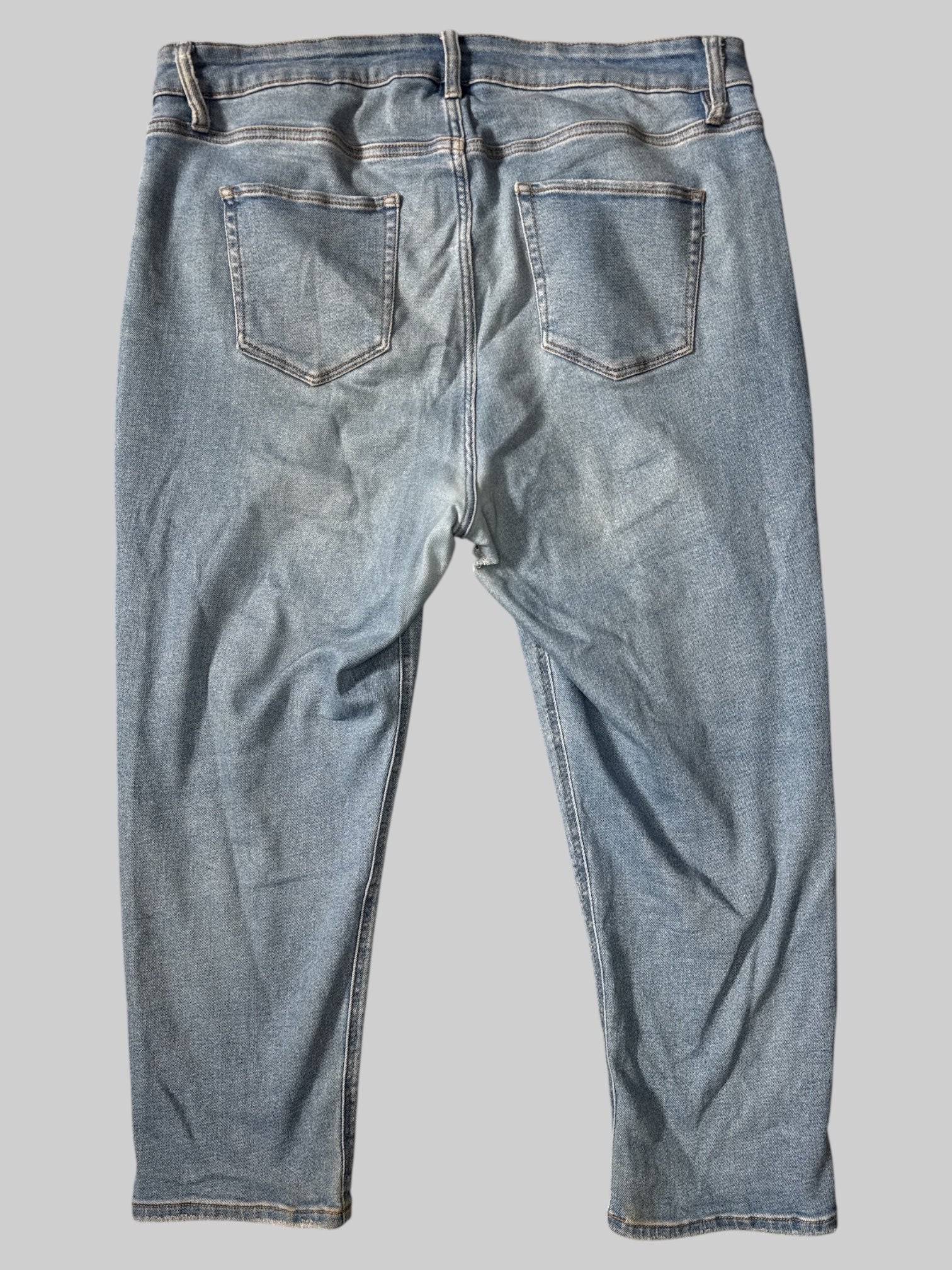 1X Blue jeans with belt loops, pockets, and distressing on knees