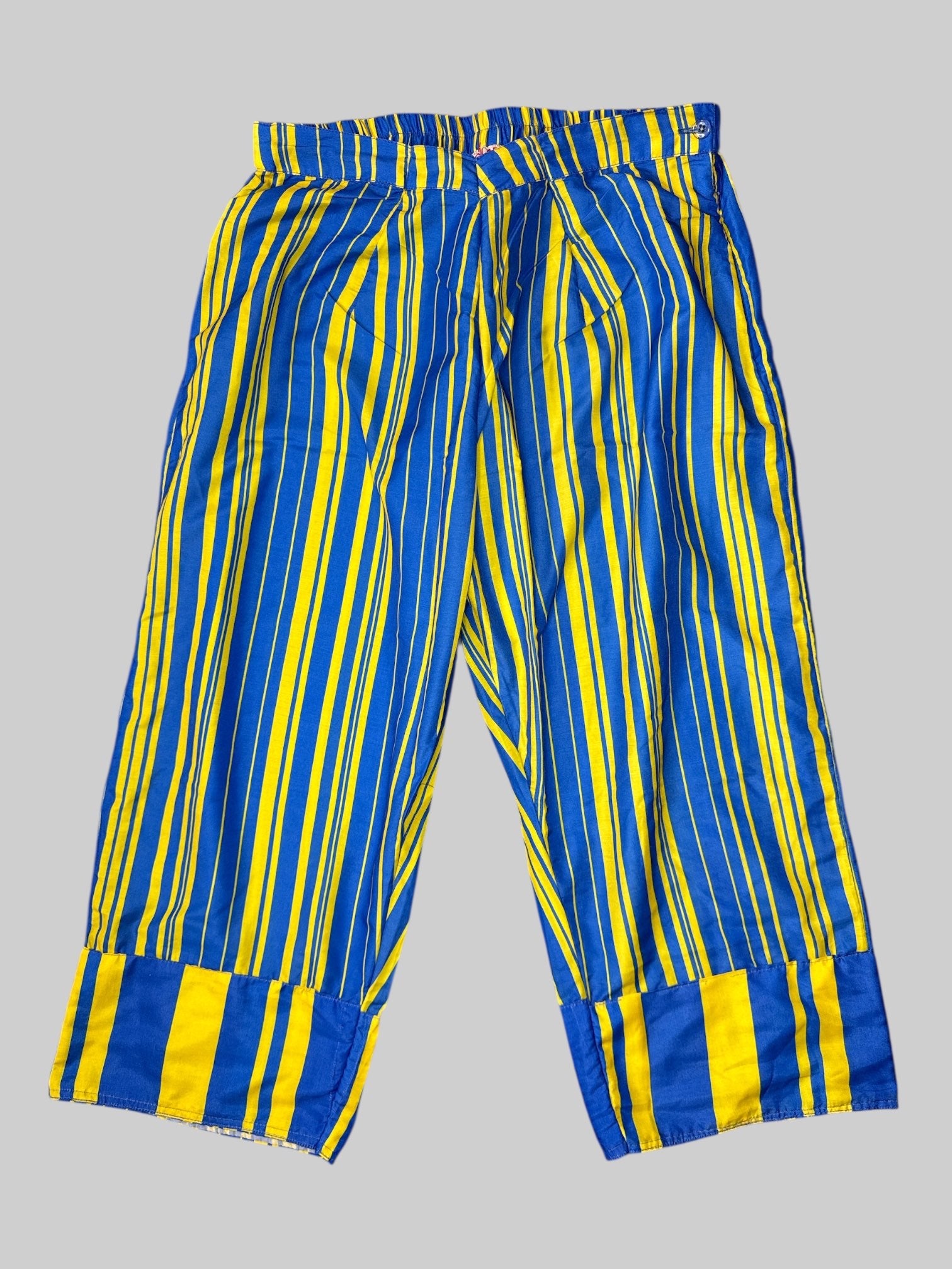 L Blue and yellow striped pants with pleated designs, cuffs, and zipper and button on side