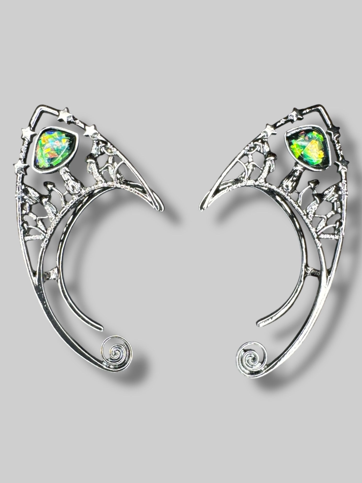 Dark metal tone ear cuffs with large bedazzled stones, stars, and mushrooms