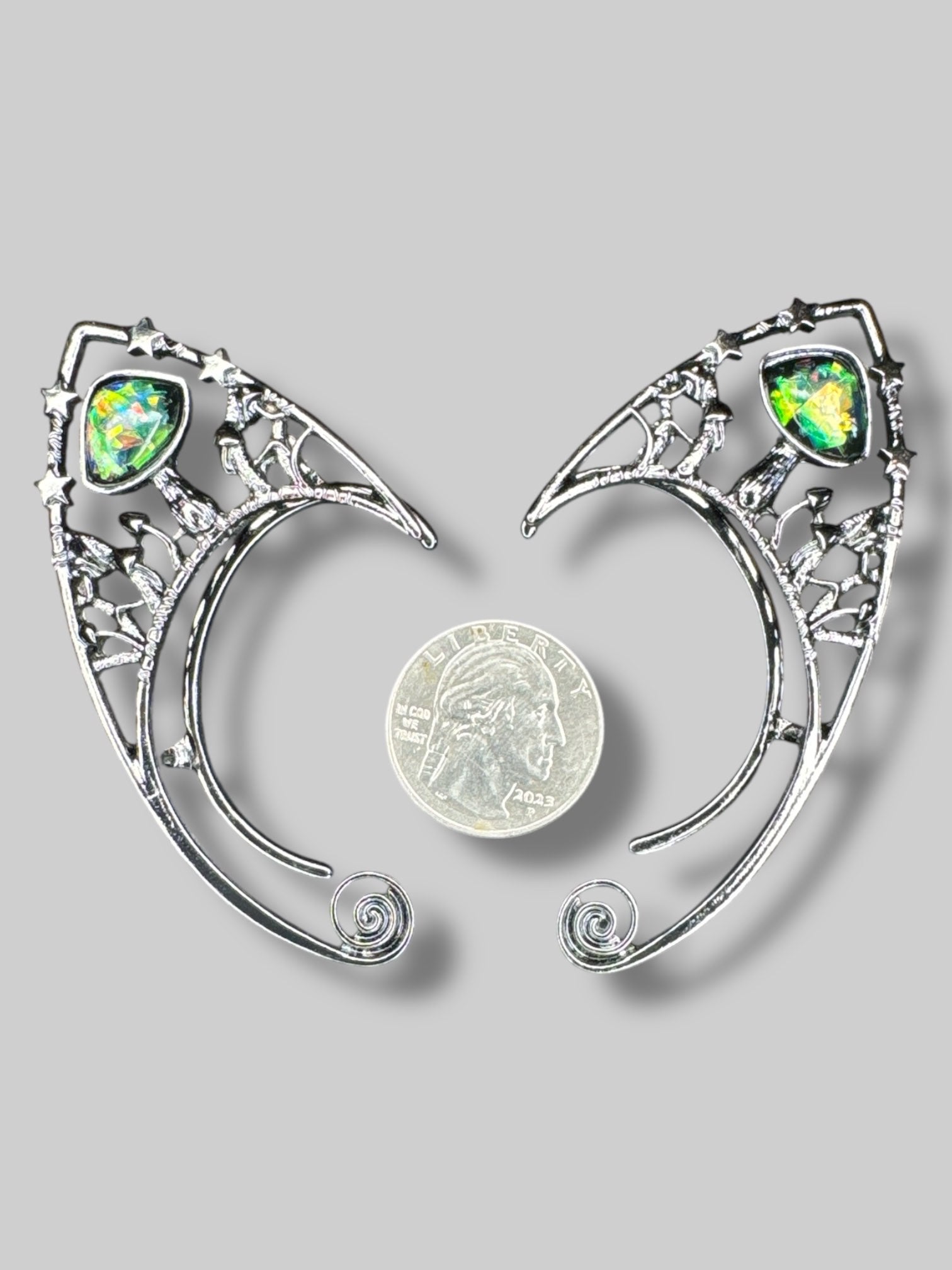 Dark metal tone ear cuffs with large bedazzled stones, stars, and mushrooms