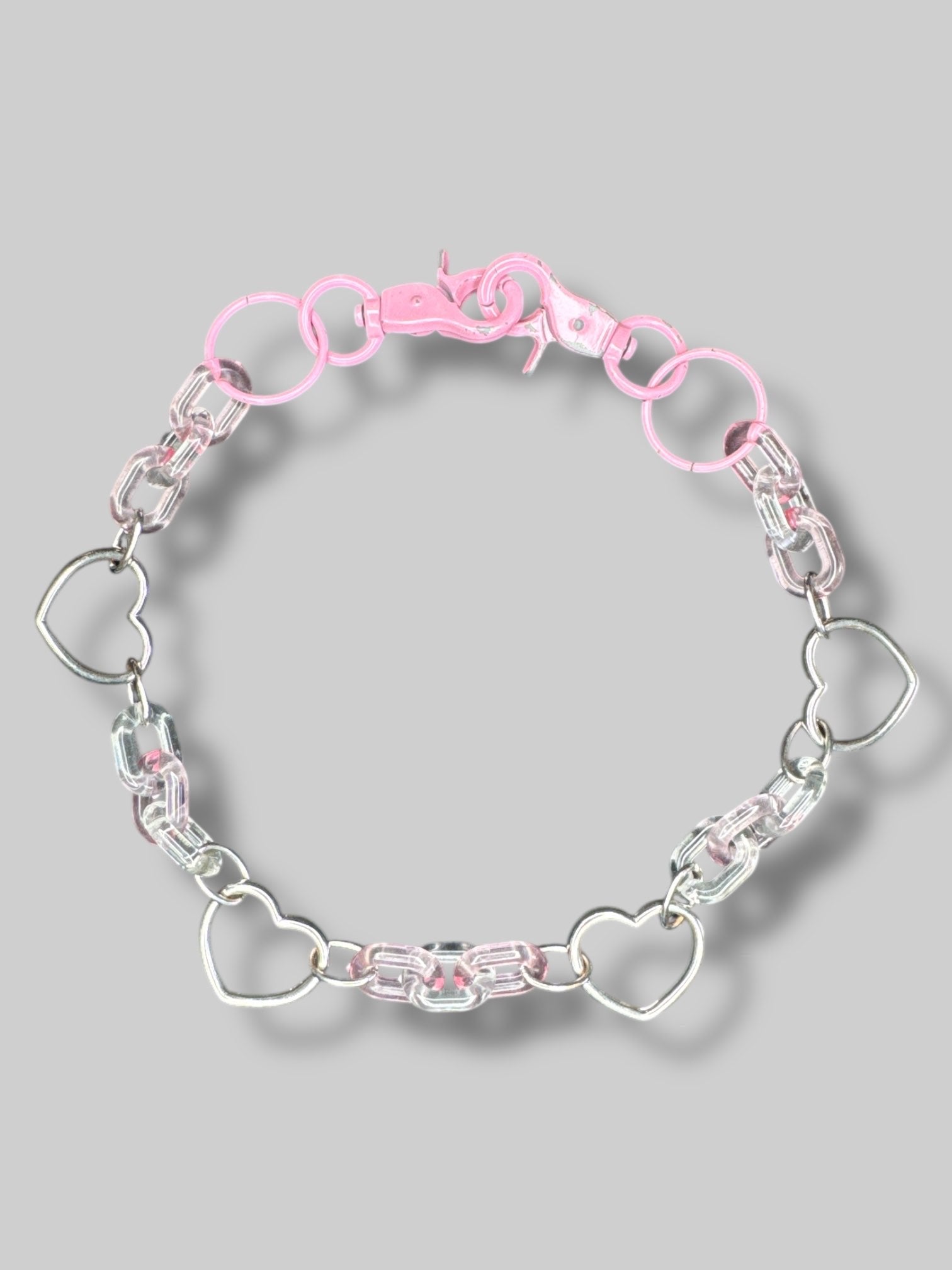 Pink silvertone and clear plastic chain with clasp closures on both sides