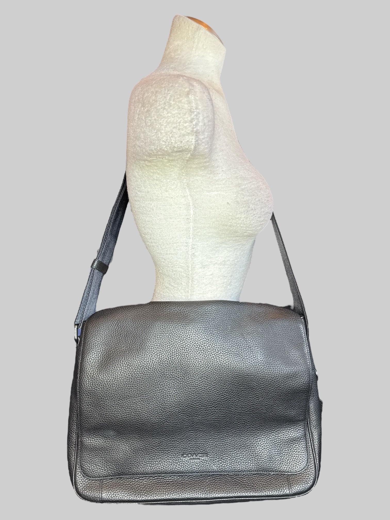 Genuine leather Coach laptop bag with multiple pockets inside, magnetic snap flap, and adjustable shoulder strap